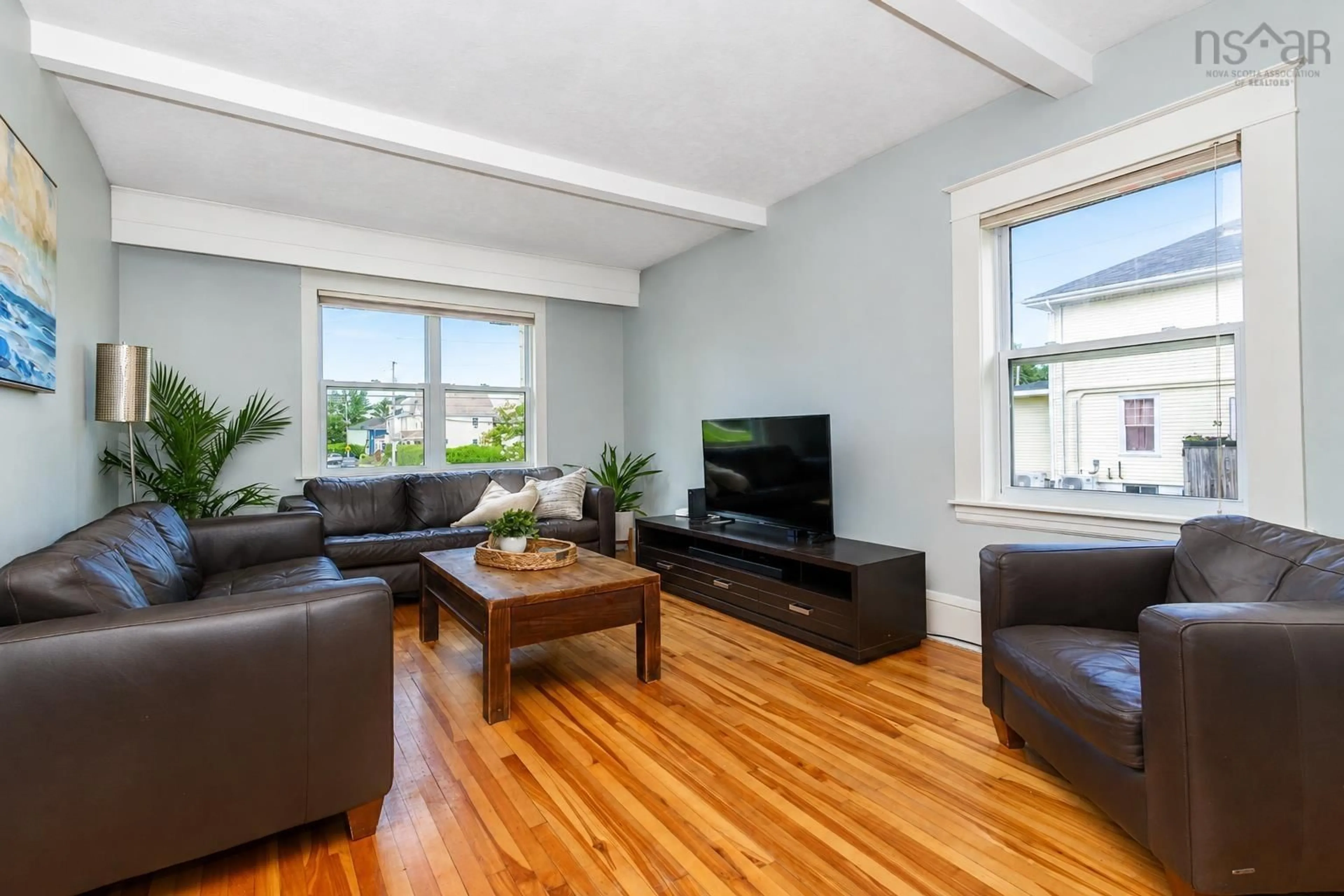 Living room with furniture, wood/laminate floor for 84 Union St, Sydney Nova Scotia B1P 4X5