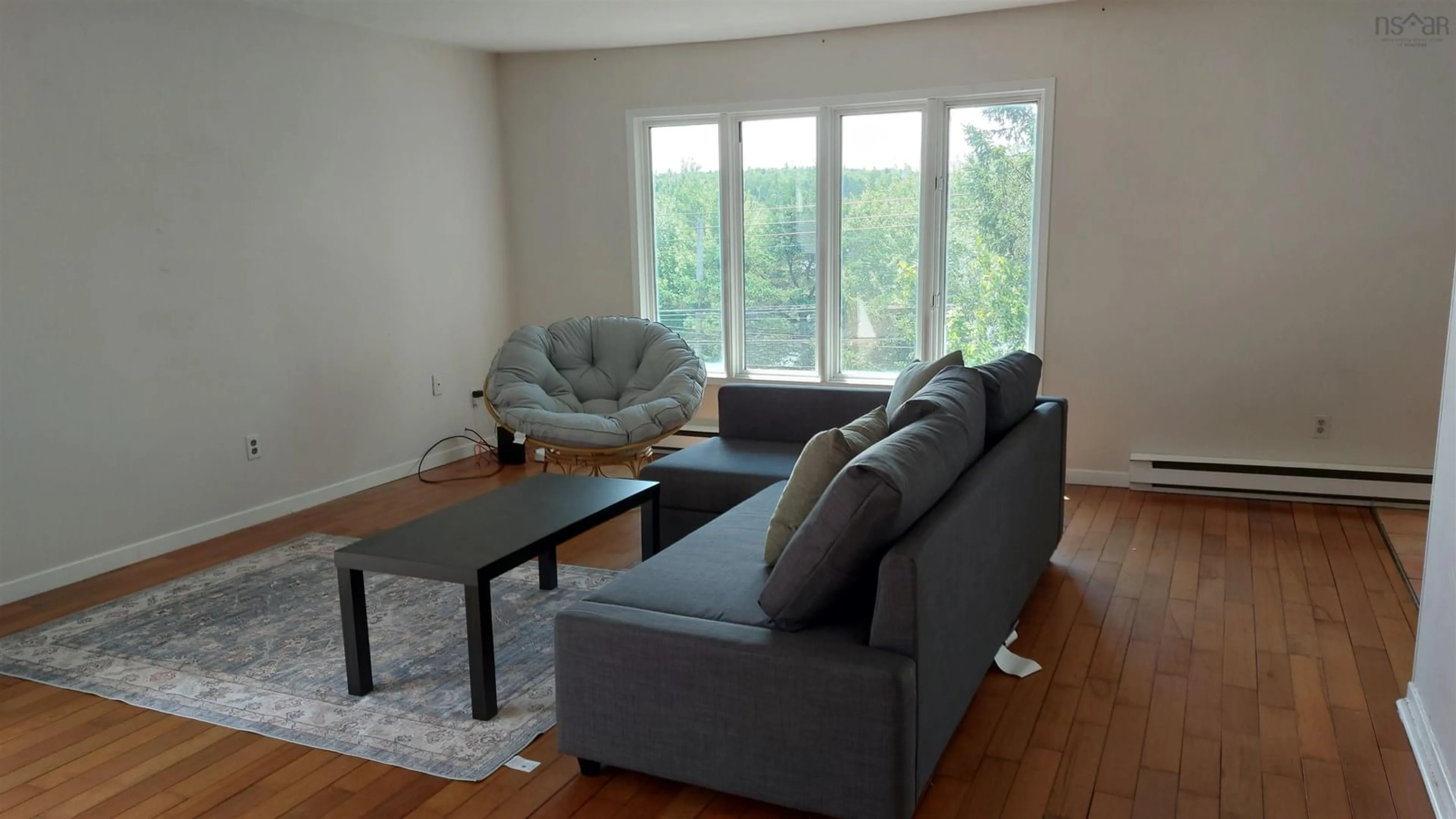 Living room with furniture, wood/laminate floor for 94 Old Sambro Rd, Spryfield Nova Scotia B3R 1R4
