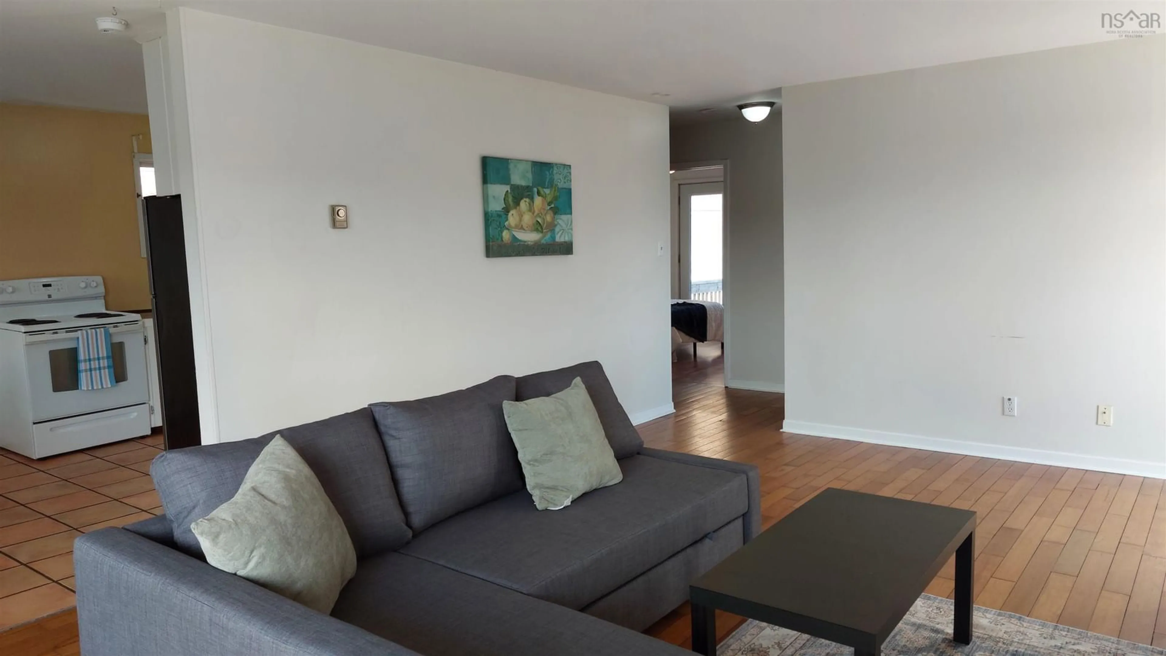 Living room with furniture, wood/laminate floor for 94 Old Sambro Rd, Spryfield Nova Scotia B3R 1R4