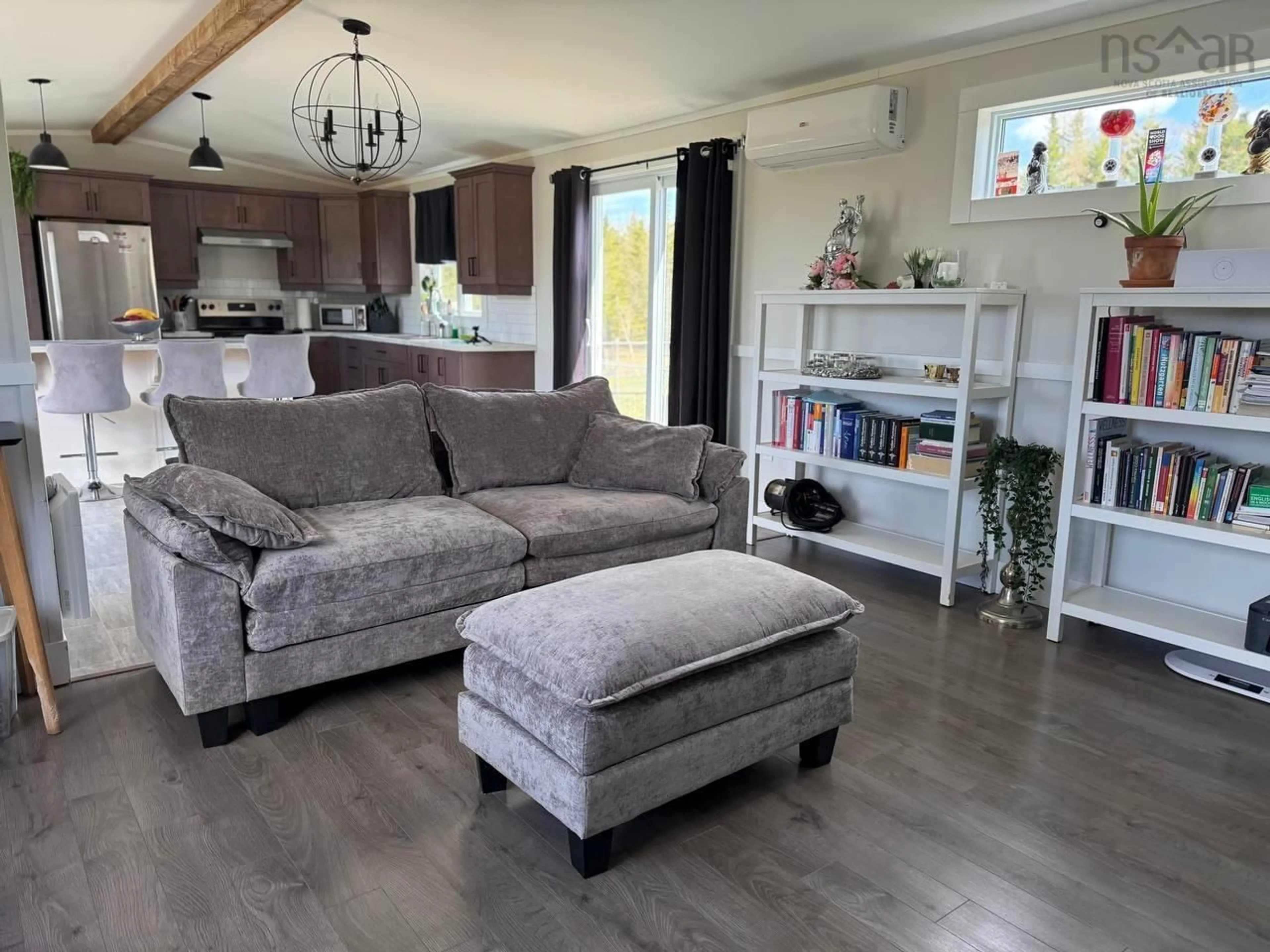 Living room with furniture, wood/laminate floor for 2185 Louisbourg Highway Hwy, Mira Road Nova Scotia B1M 1A9