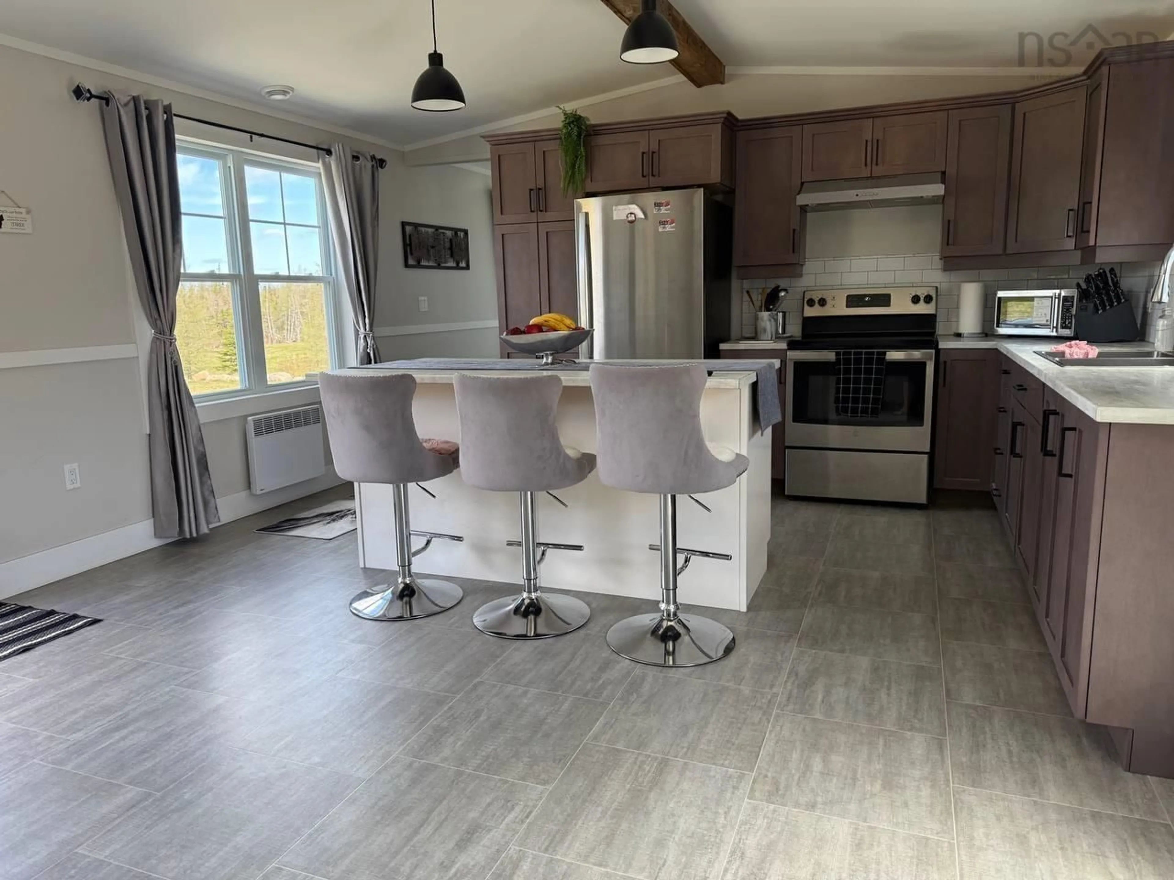 Open concept kitchen, wood/laminate floor for 2185 Louisbourg Highway Hwy, Mira Road Nova Scotia B1M 1A9