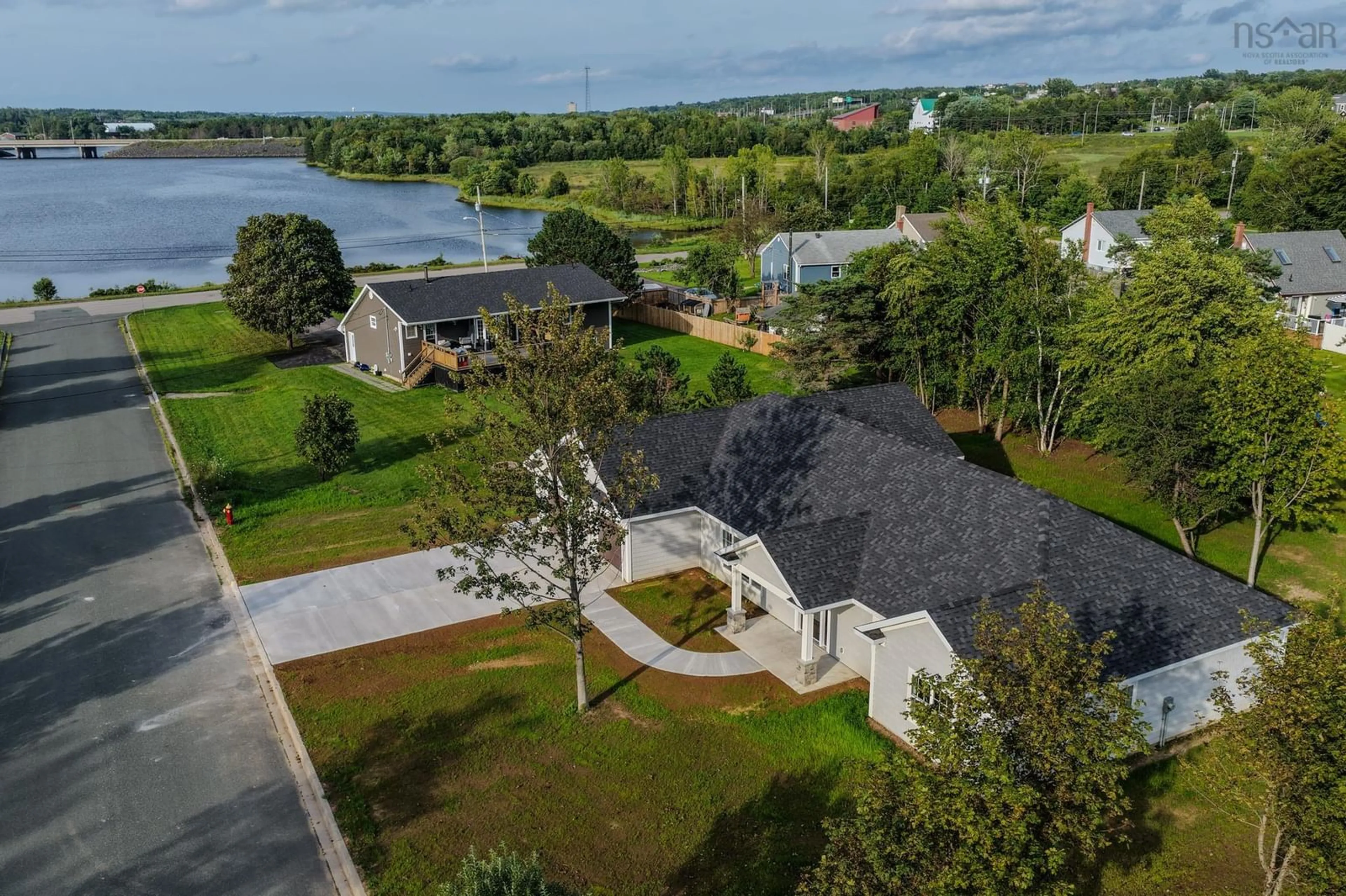 A pic from outside/outdoor area/front of a property/back of a property/a pic from drone, water/lake/river/ocean view for 18 Ethan St, Sydney River Nova Scotia B1S 0G7