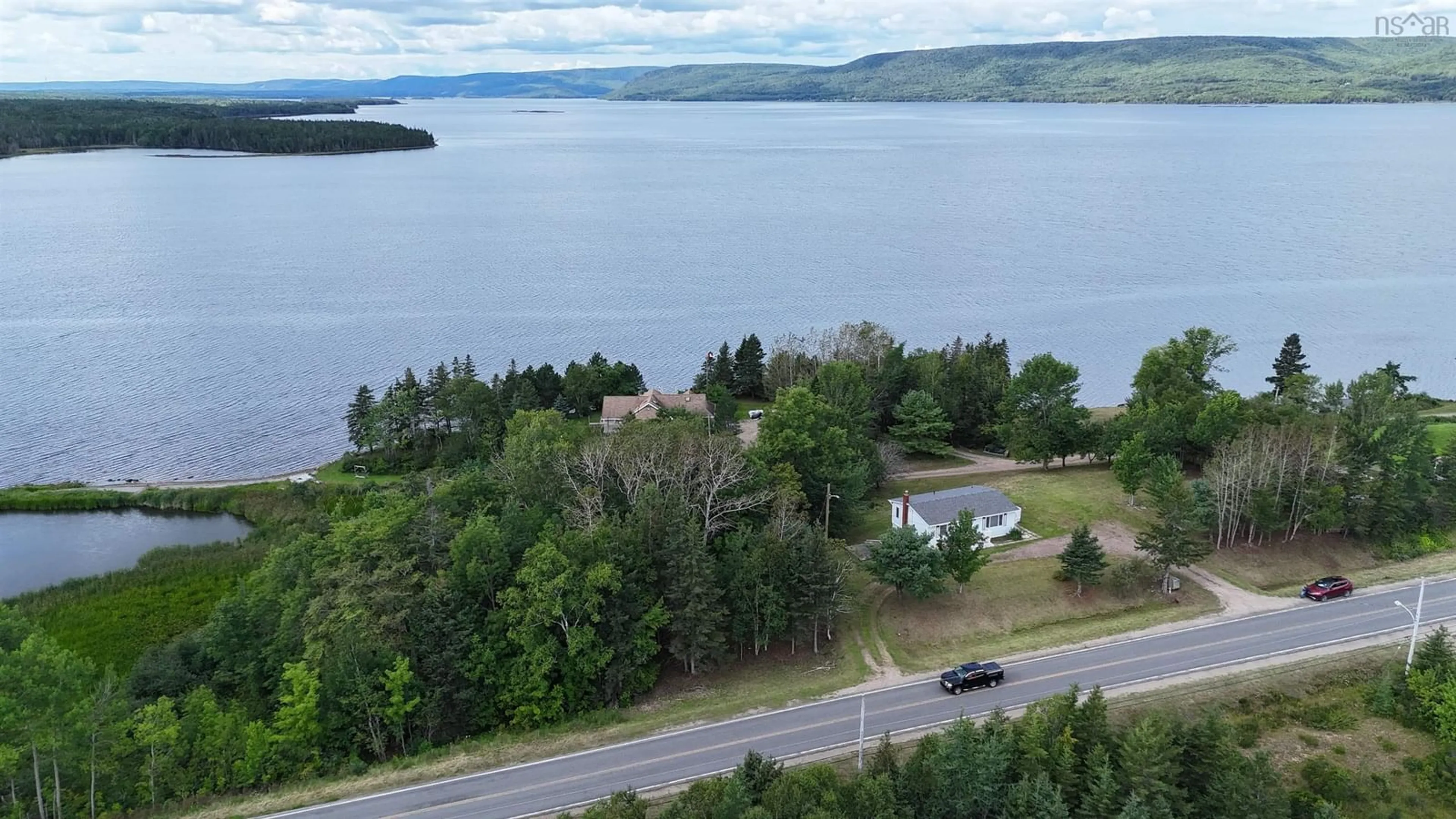 A pic from outside/outdoor area/front of a property/back of a property/a pic from drone, water/lake/river/ocean view for 642 223 Hwy, Little Narrows Nova Scotia B0E 1T0