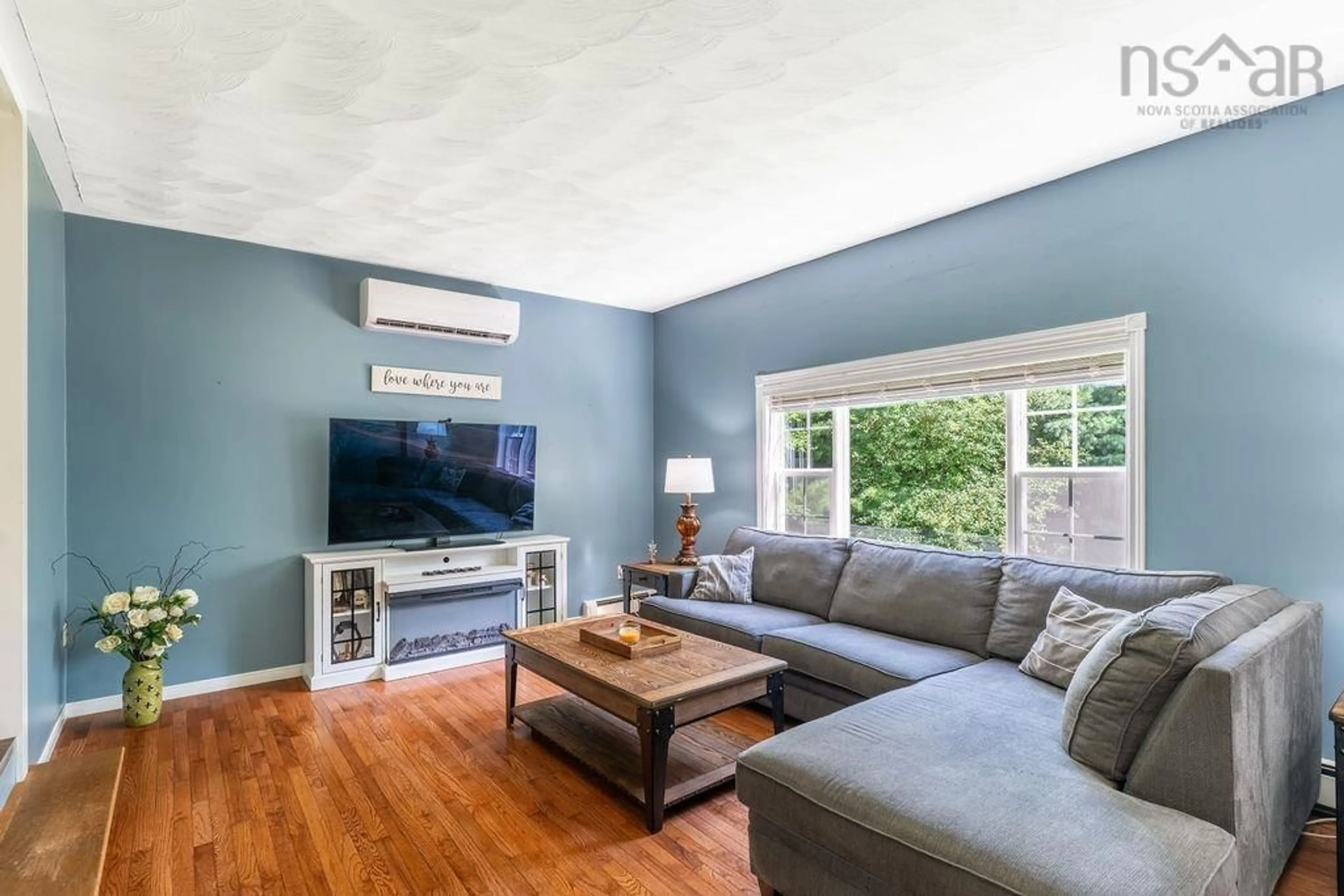 Living room with furniture, wood/laminate floor for 816 Myra Rd, Porters Lake Nova Scotia B3E 1G5