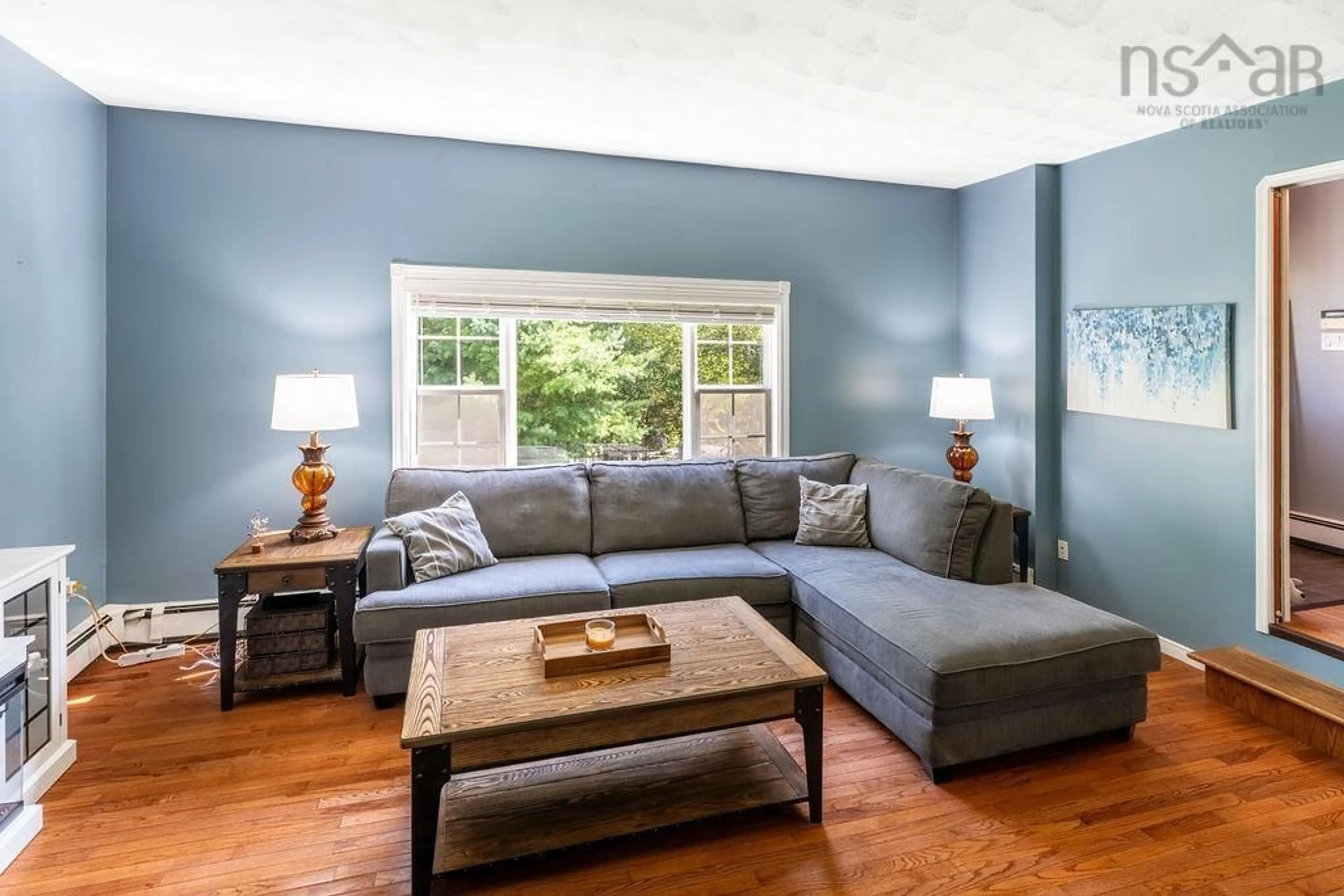 Living room with furniture, wood/laminate floor for 816 Myra Rd, Porters Lake Nova Scotia B3E 1G5