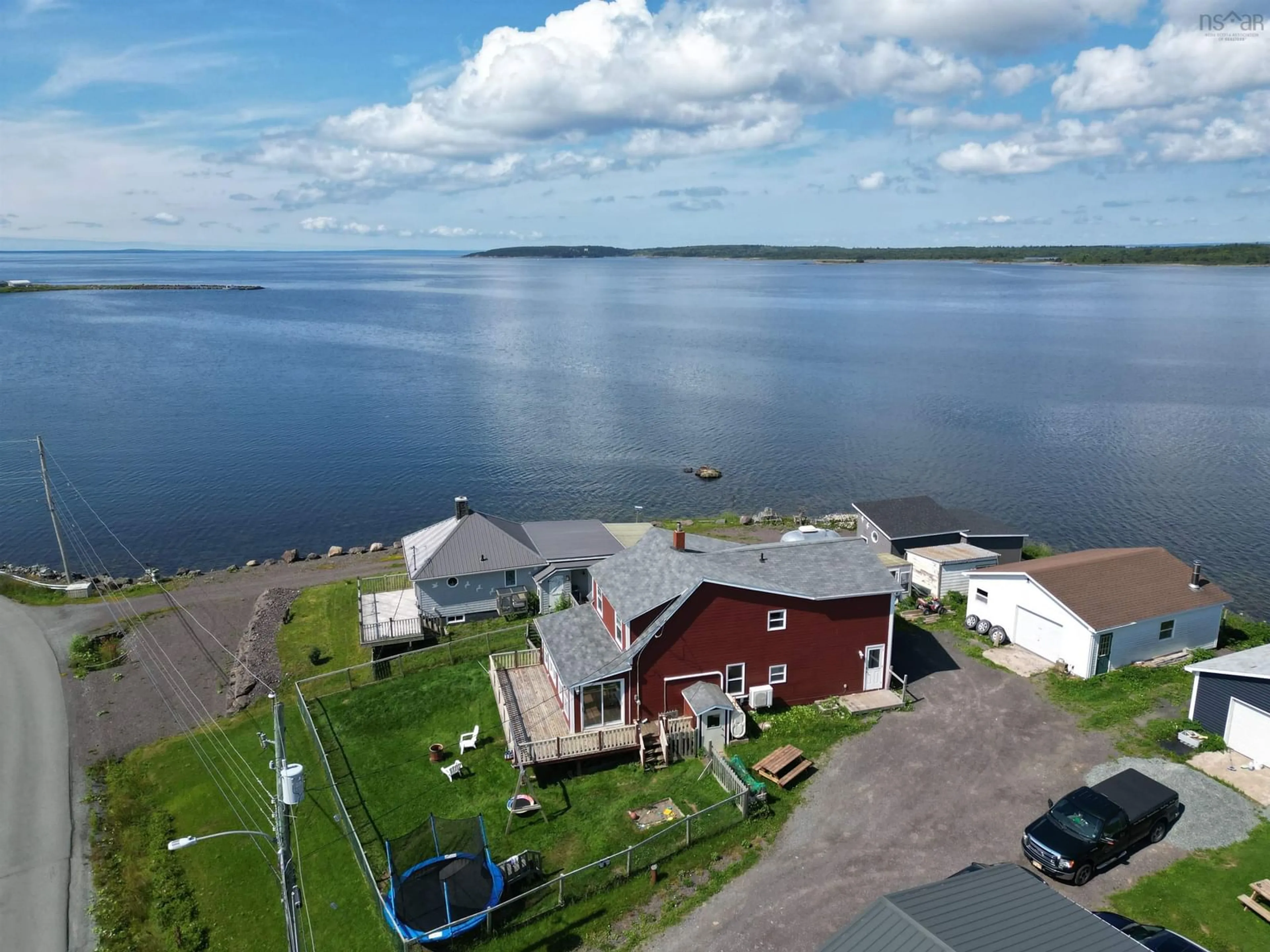 A pic from outside/outdoor area/front of a property/back of a property/a pic from drone, water/lake/river/ocean view for 276 Southside Petit De Grat Rd., Alderney Point Nova Scotia B0E 2L0