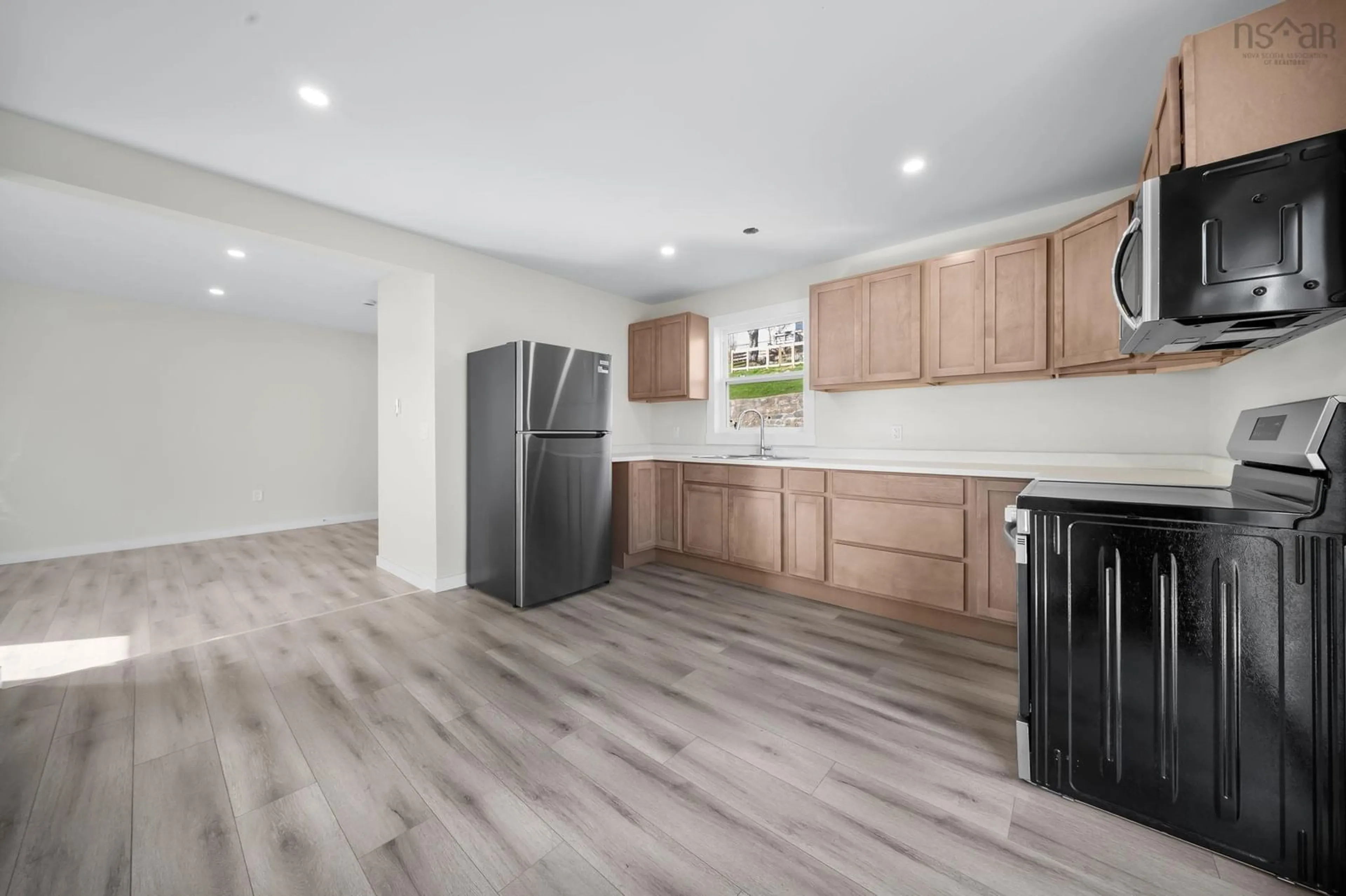 Open concept kitchen, wood/laminate floor for 56 Irving St, Dartmouth Nova Scotia B2W 1K2