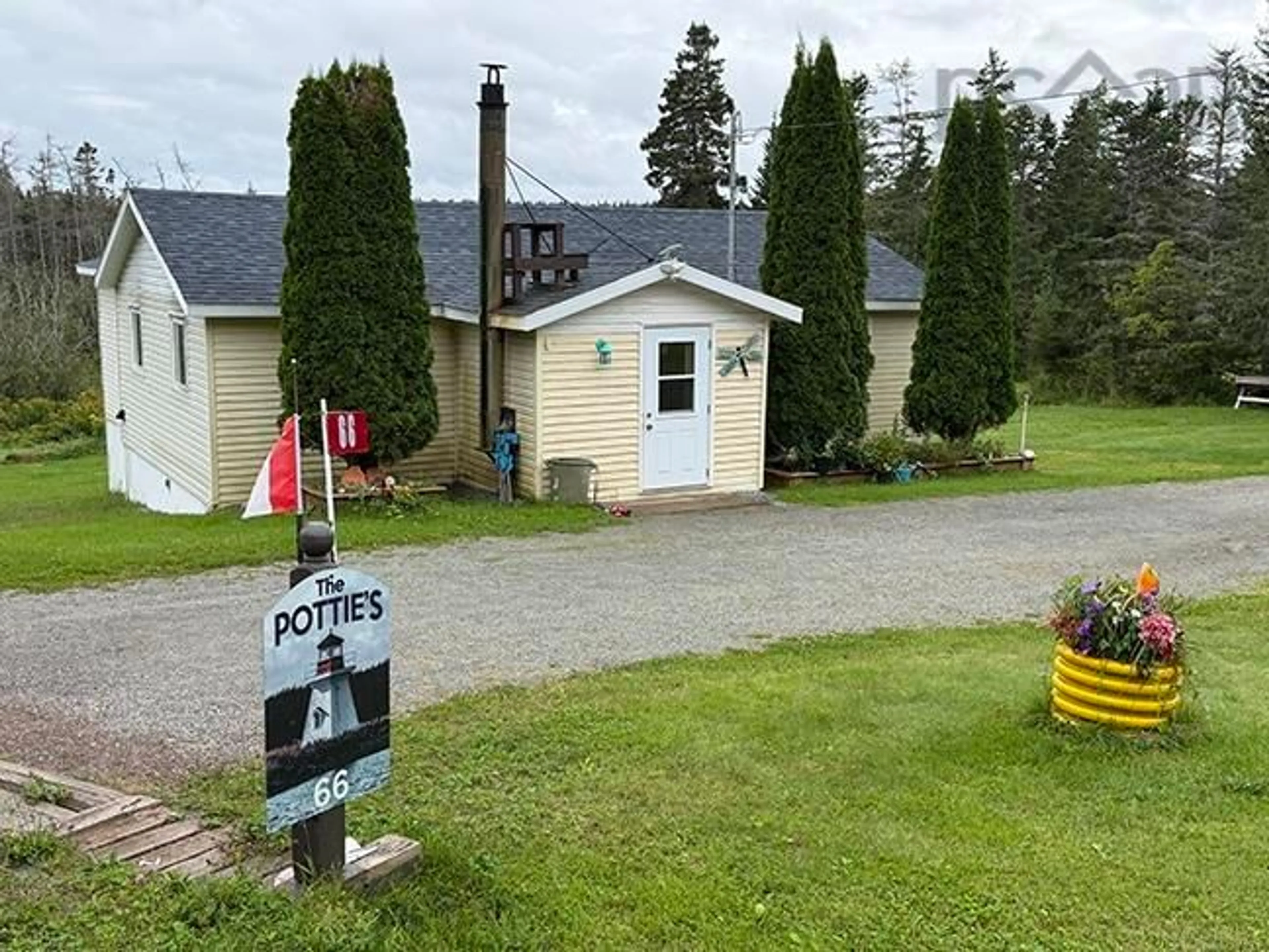 A pic from outside/outdoor area/front of a property/back of a property/a pic from drone, street for 66 Richards Pond Rd, River Bourgeois Nova Scotia B0E 2X0