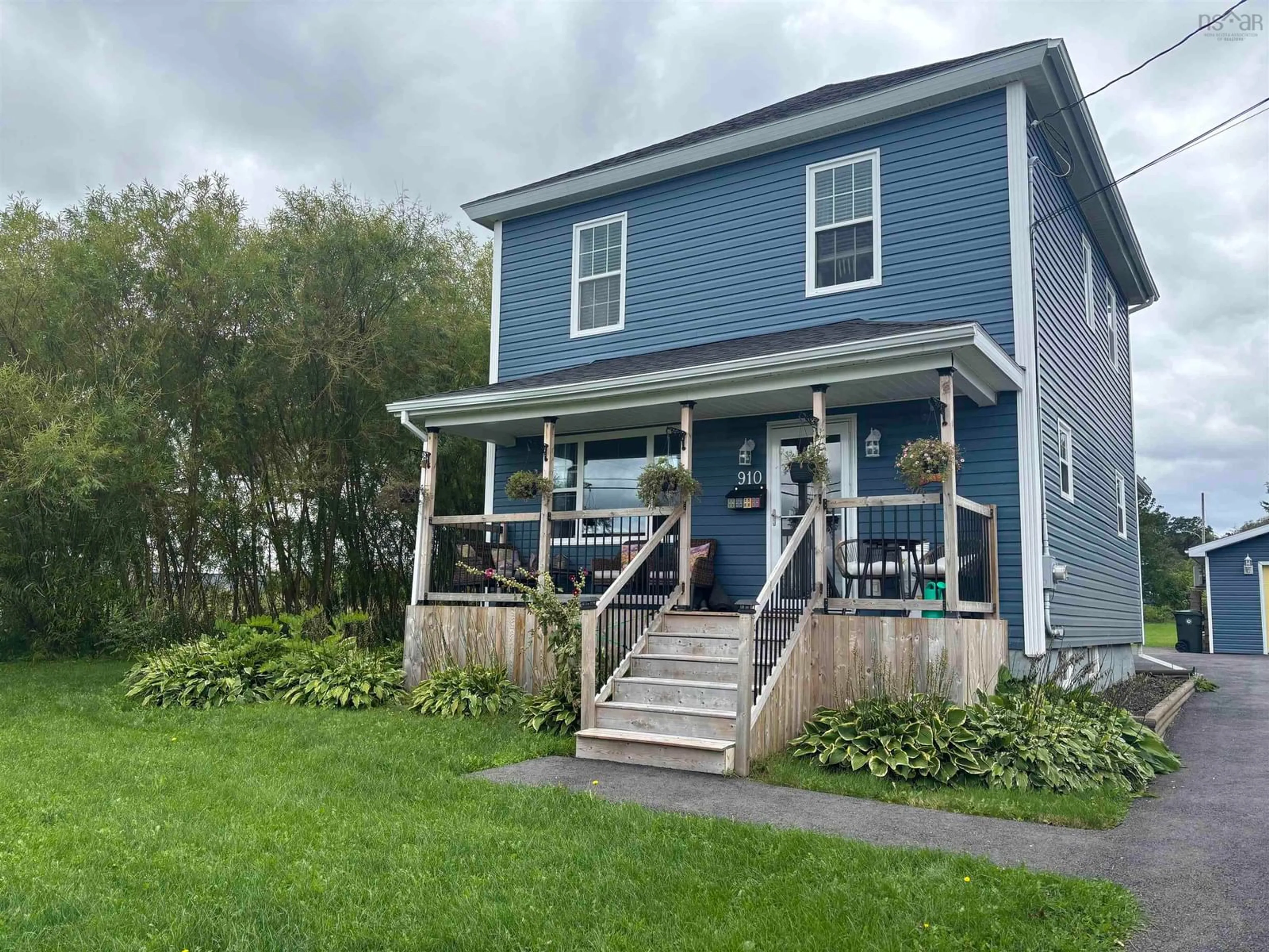 Home with vinyl exterior material, street for 910 Shore Road, Sydney Mines Nova Scotia B1V 1B3