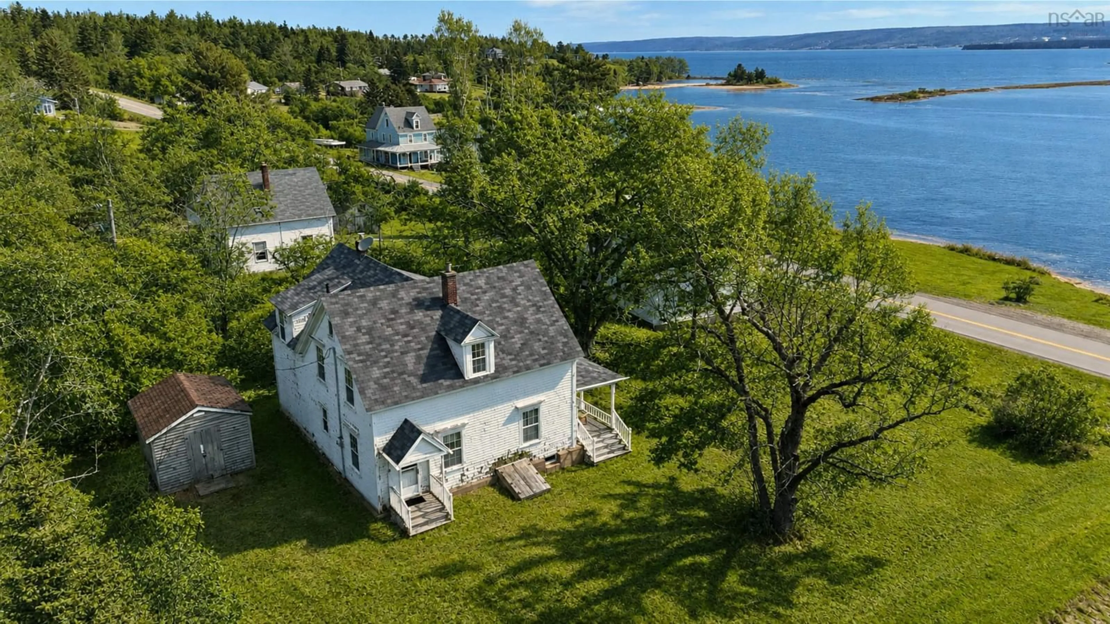 A pic from outside/outdoor area/front of a property/back of a property/a pic from drone, water/lake/river/ocean view for 2145 Marble Mountain Rd, West Bay Nova Scotia B0E 3K0