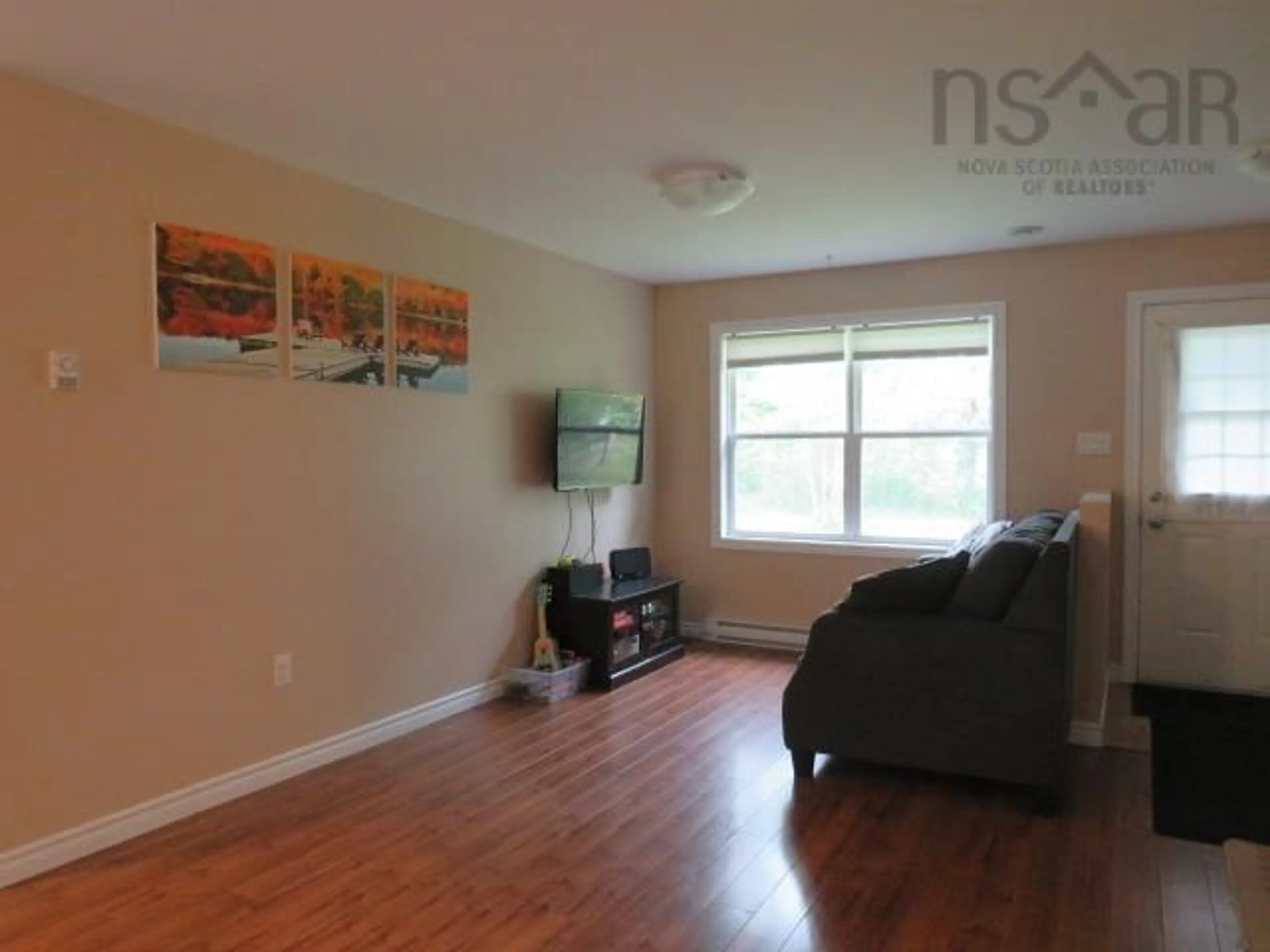 Living room with furniture, wood/laminate floor for 440 Woodville Rd, Greenhill Nova Scotia B0N 2A0