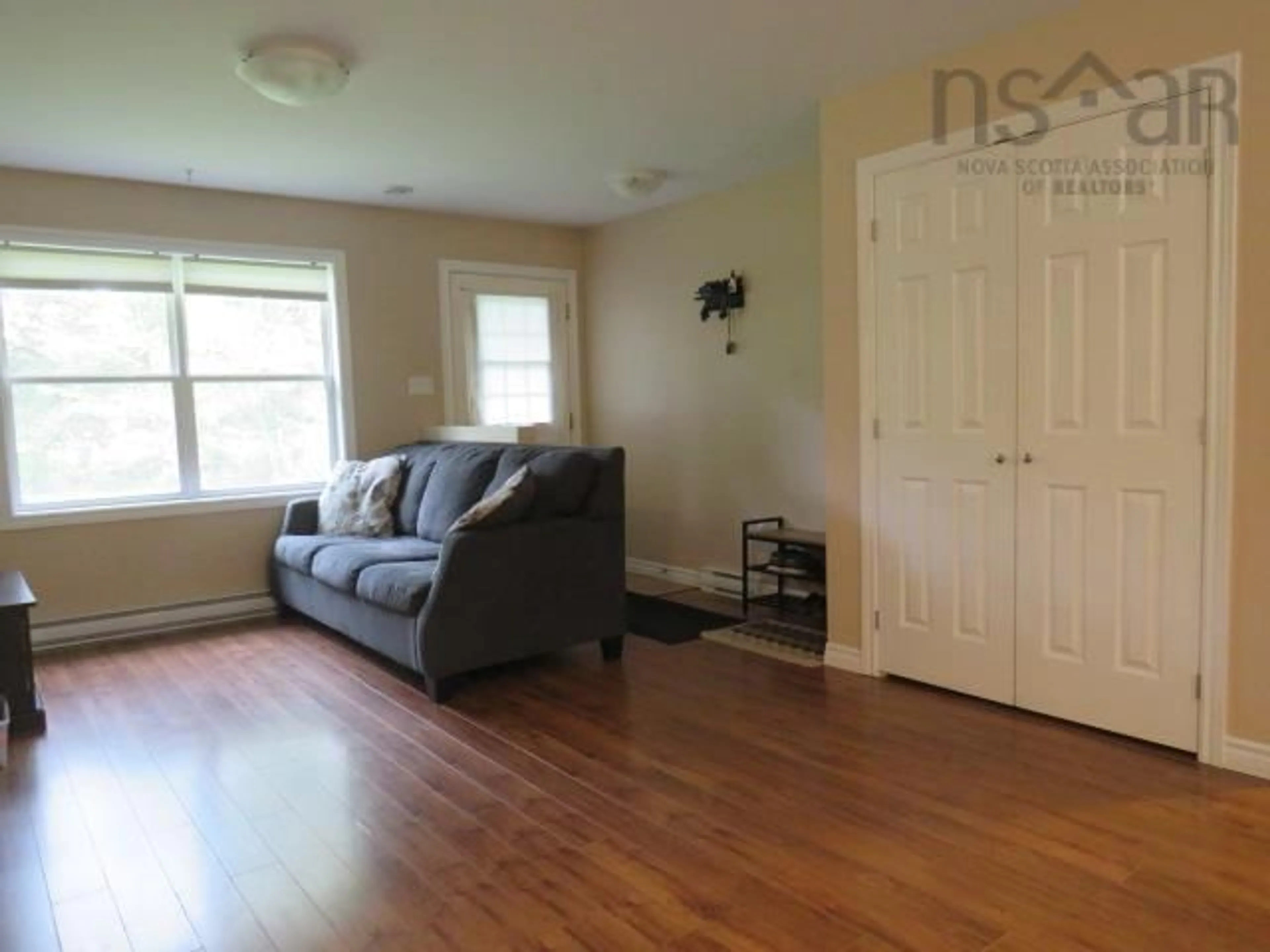 Living room with furniture, wood/laminate floor for 440 Woodville Rd, Greenhill Nova Scotia B0N 2A0