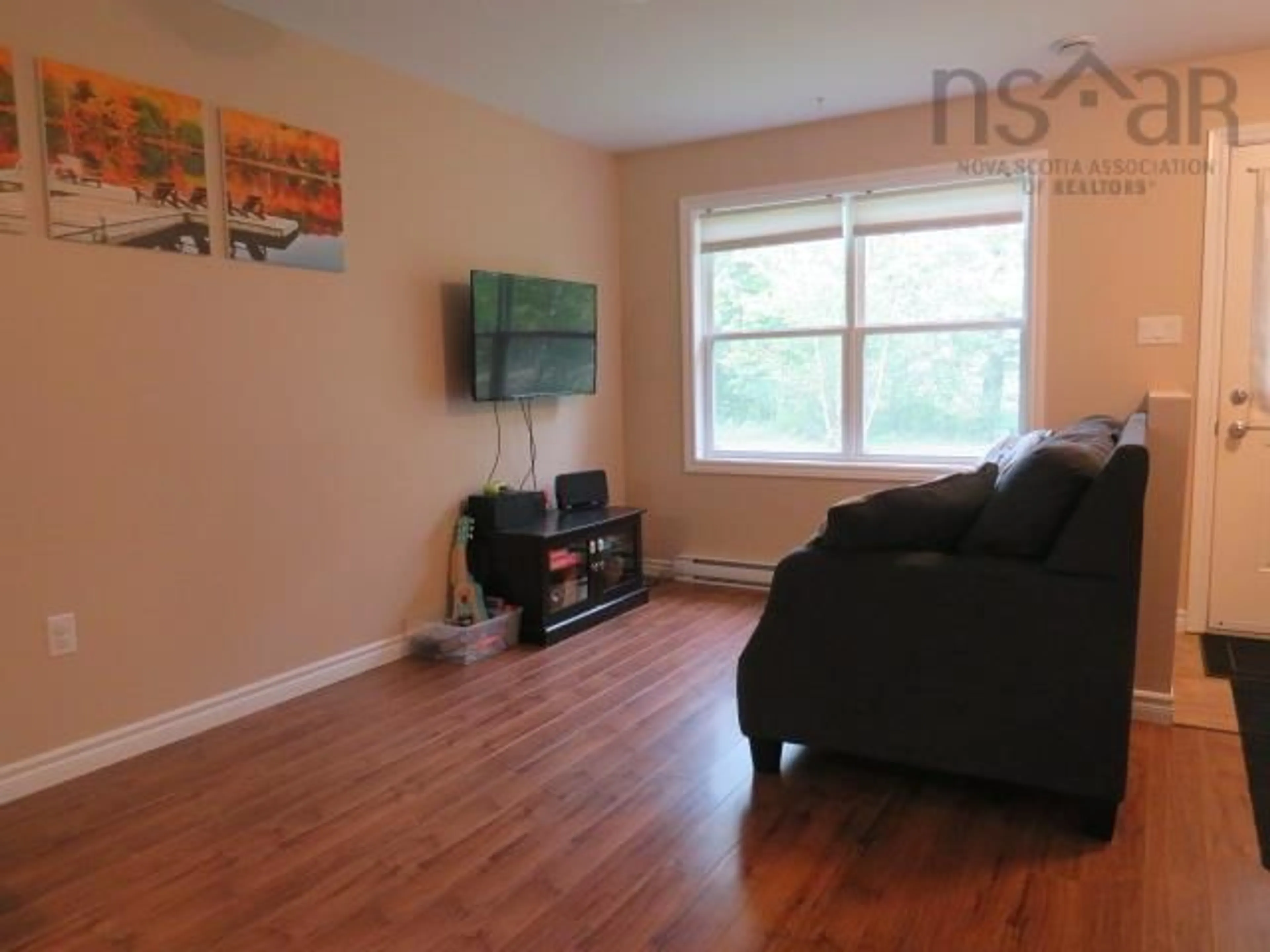 Living room with furniture, wood/laminate floor for 440 Woodville Rd, Greenhill Nova Scotia B0N 2A0