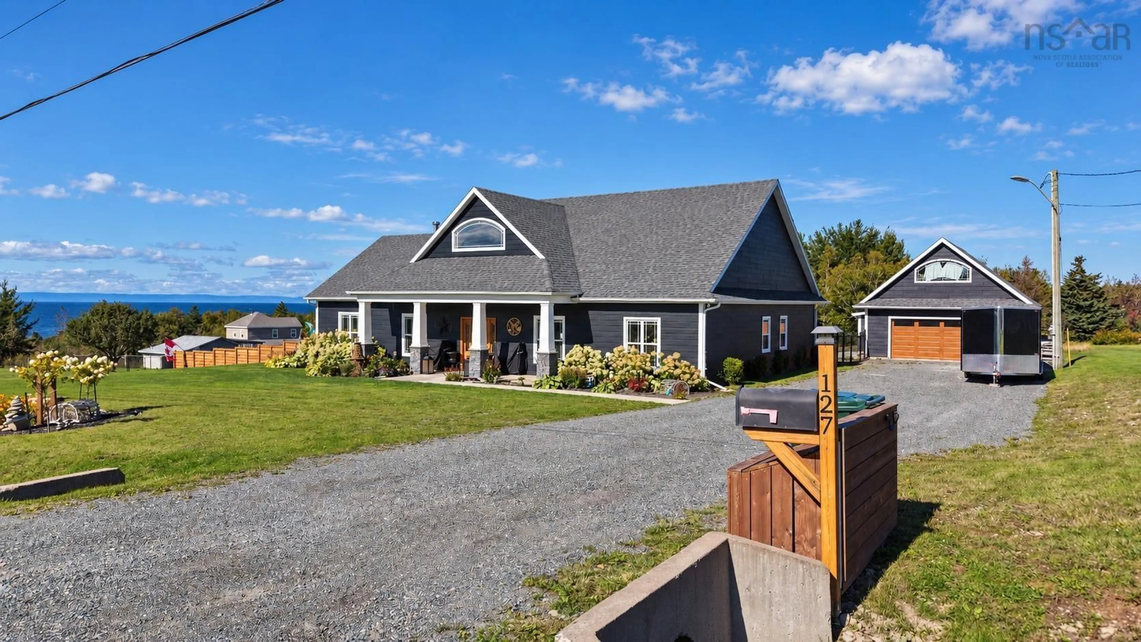 A pic from outside/outdoor area/front of a property/back of a property/a pic from drone, water/lake/river/ocean view for 127 Lake Rd, Victoria Mines Nova Scotia B1N 3J7
