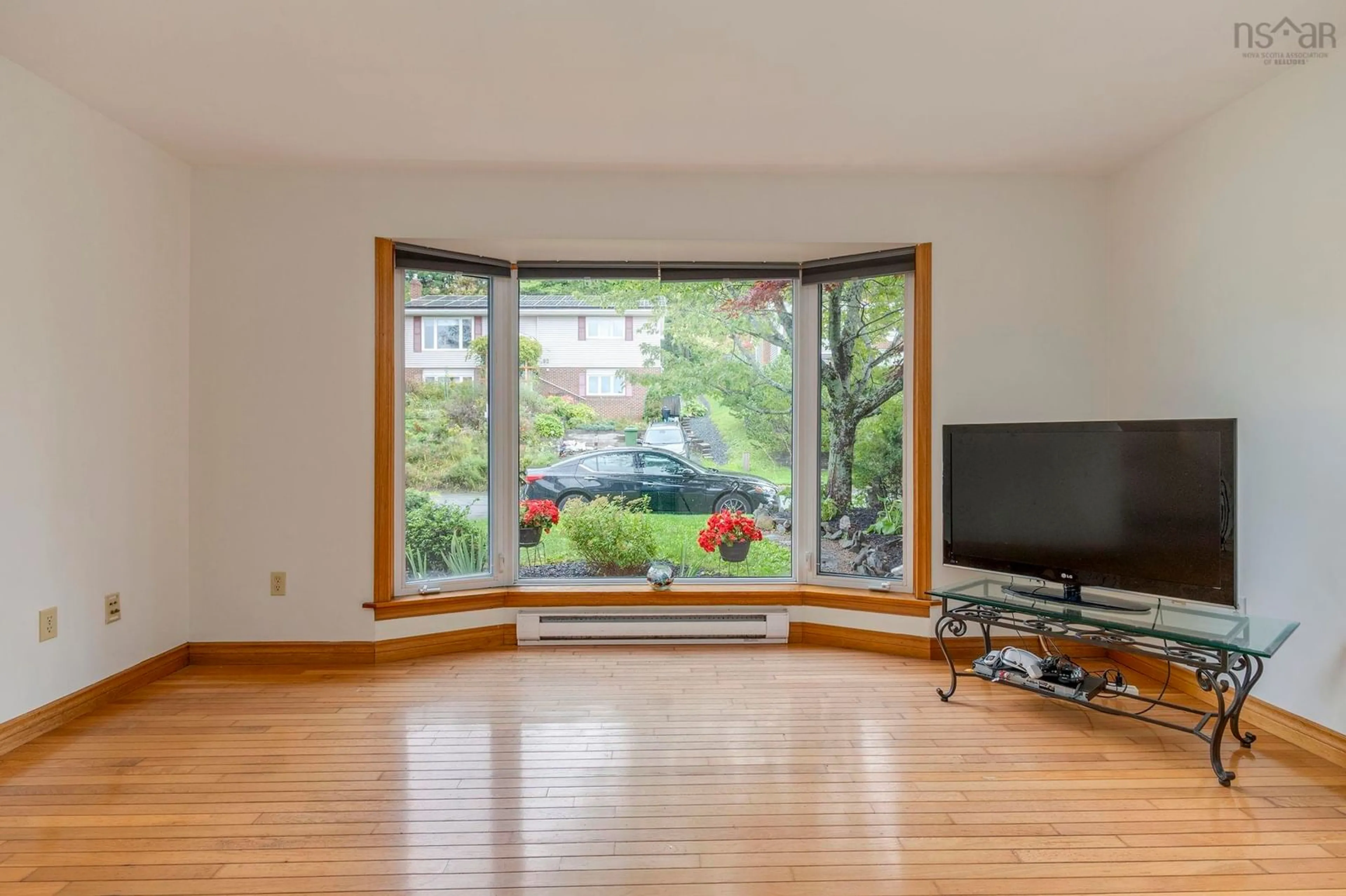 Living room with furniture, wood/laminate floor for 93 Regal Rd, Dartmouth Nova Scotia B2W 4E9