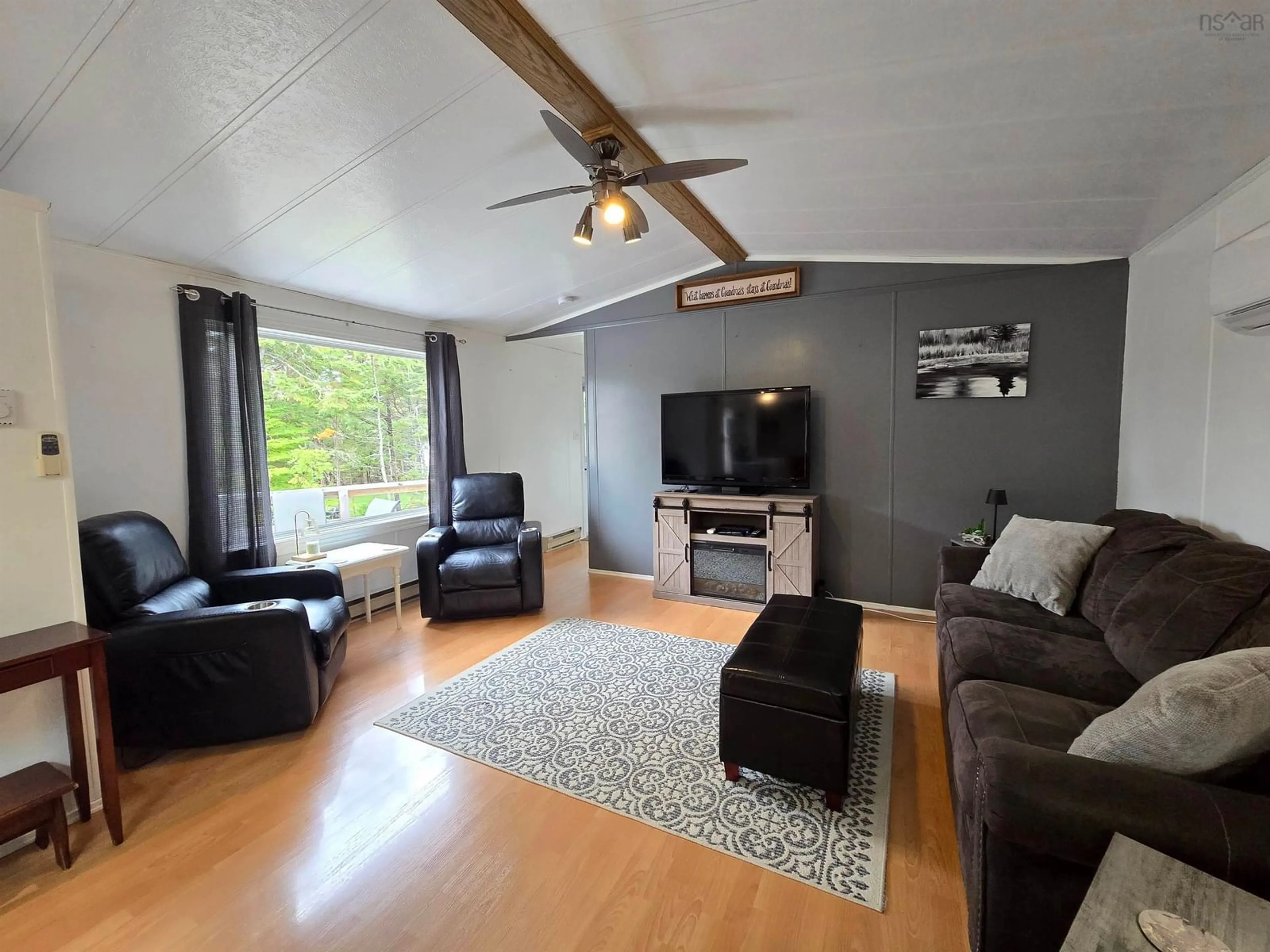Living room with furniture, wood/laminate floor for 69 De Raymond St, St. Peter's Nova Scotia B0E 3B0