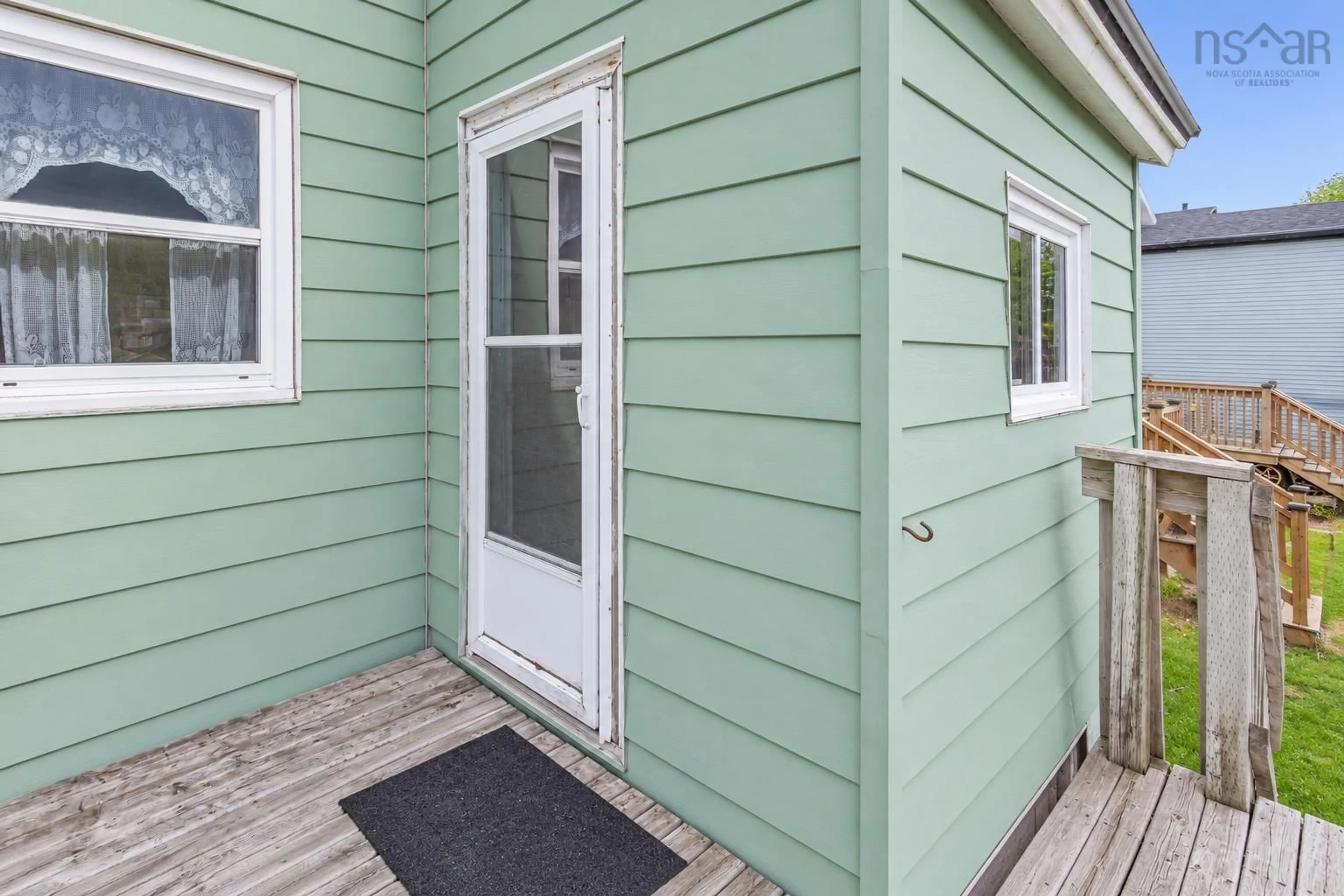 Home with vinyl exterior material, street for 21 Railroad St, Whitney Pier Nova Scotia B1N 2B3