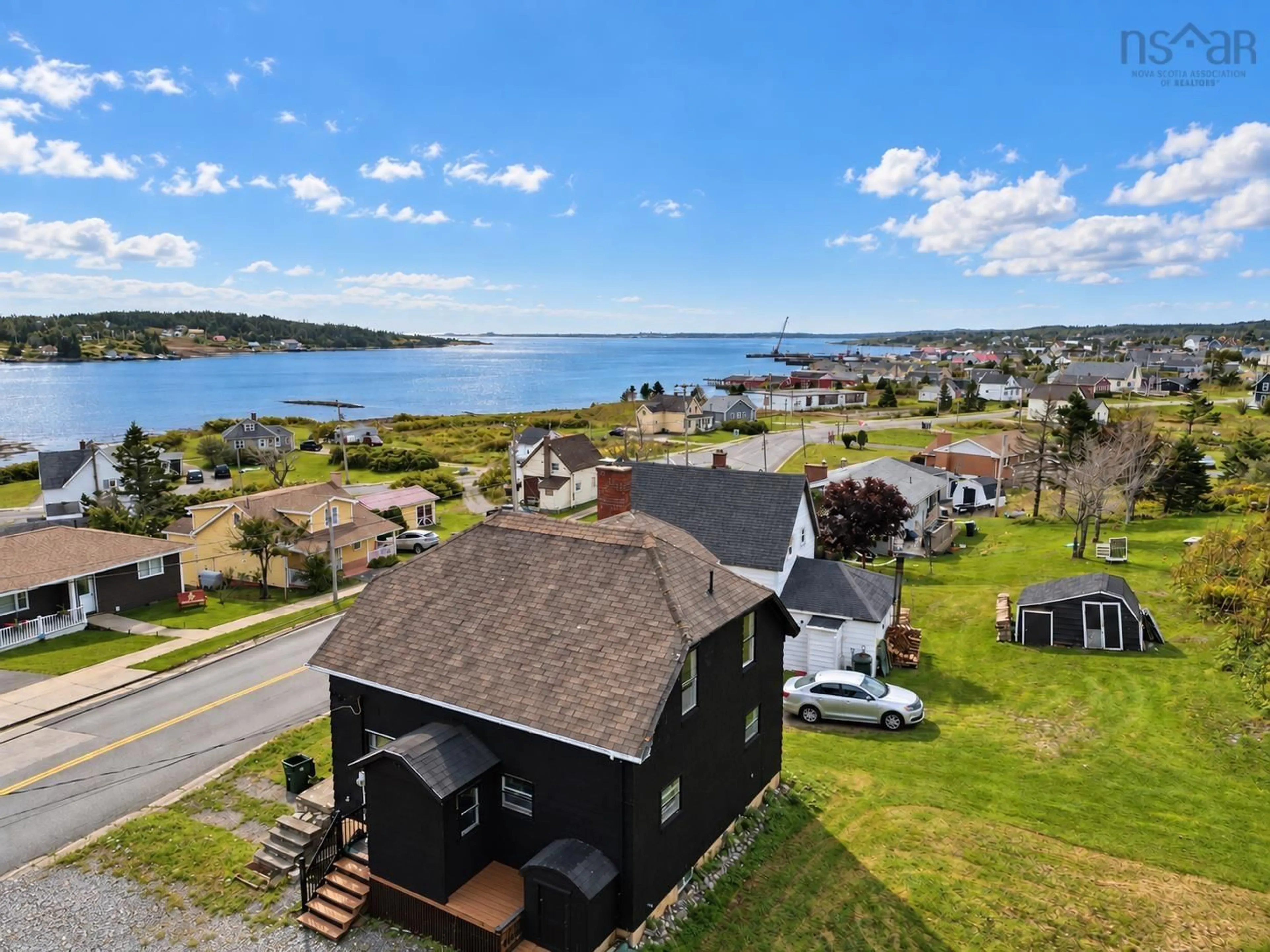 A pic from outside/outdoor area/front of a property/back of a property/a pic from drone, water/lake/river/ocean view for 7368 Main St, Louisbourg Nova Scotia B1C 1P5