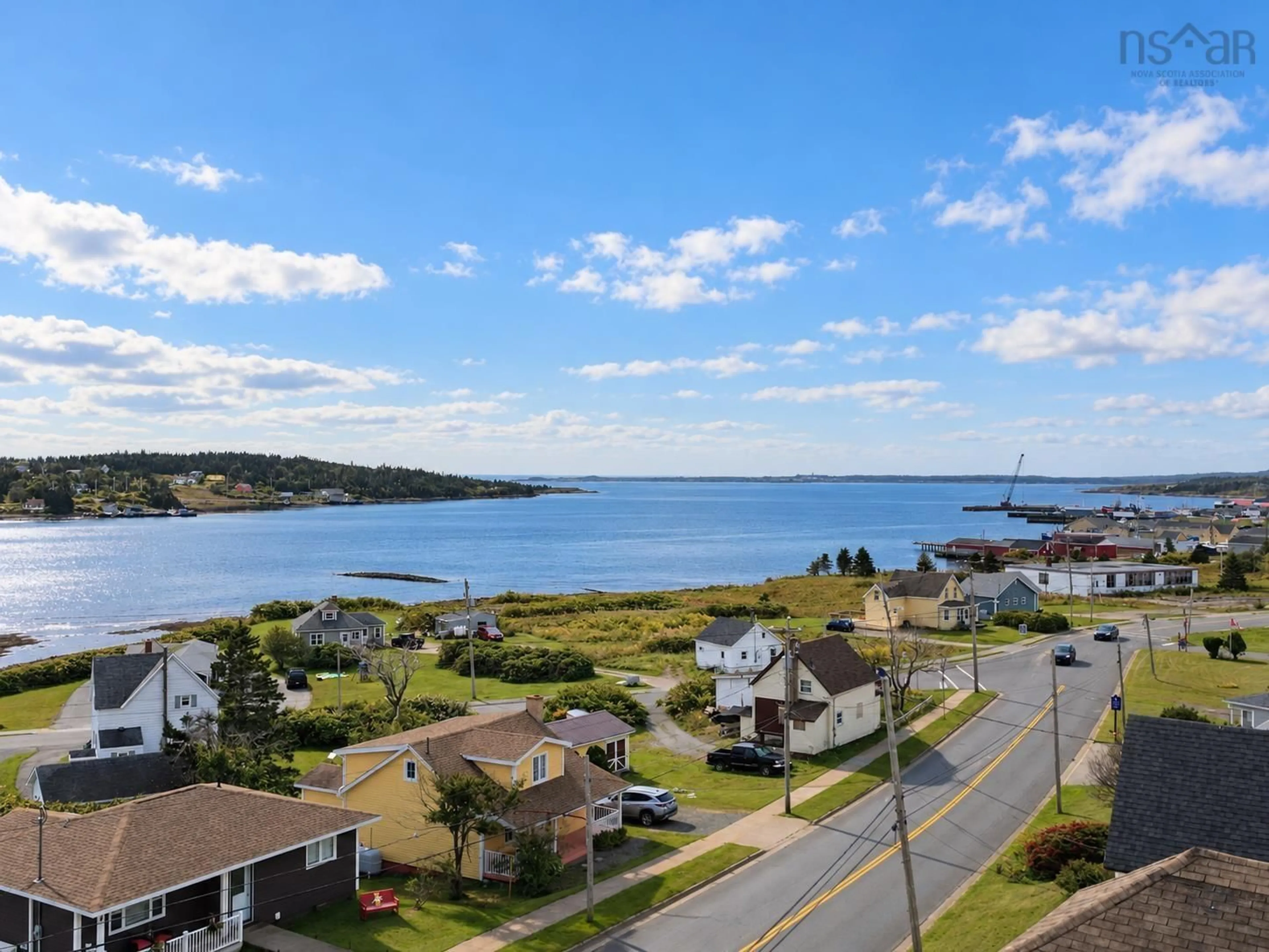 A pic from outside/outdoor area/front of a property/back of a property/a pic from drone, water/lake/river/ocean view for 7368 Main St, Louisbourg Nova Scotia B1C 1P5