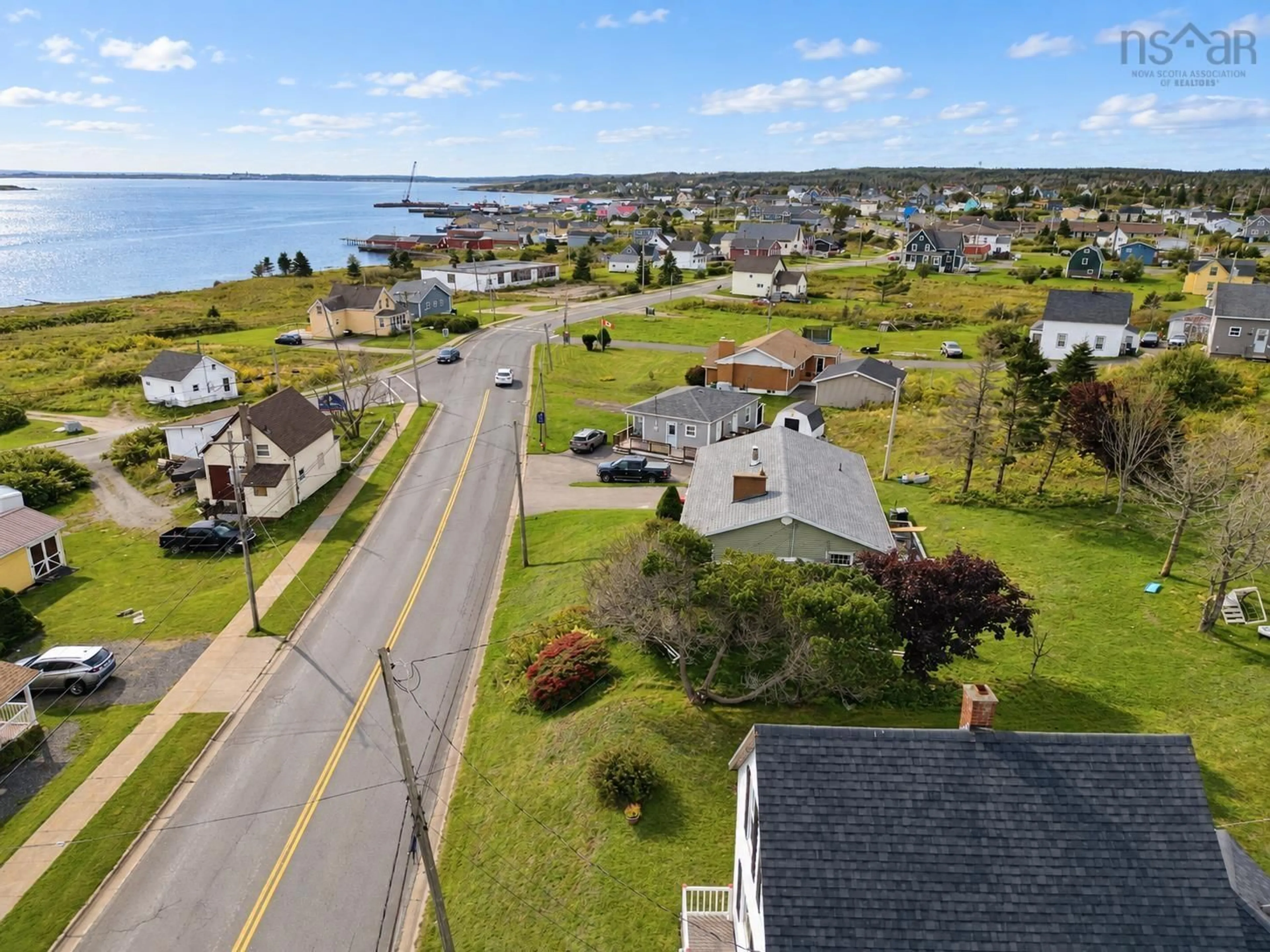 A pic from outside/outdoor area/front of a property/back of a property/a pic from drone, water/lake/river/ocean view for 7368 Main St, Louisbourg Nova Scotia B1C 1P5