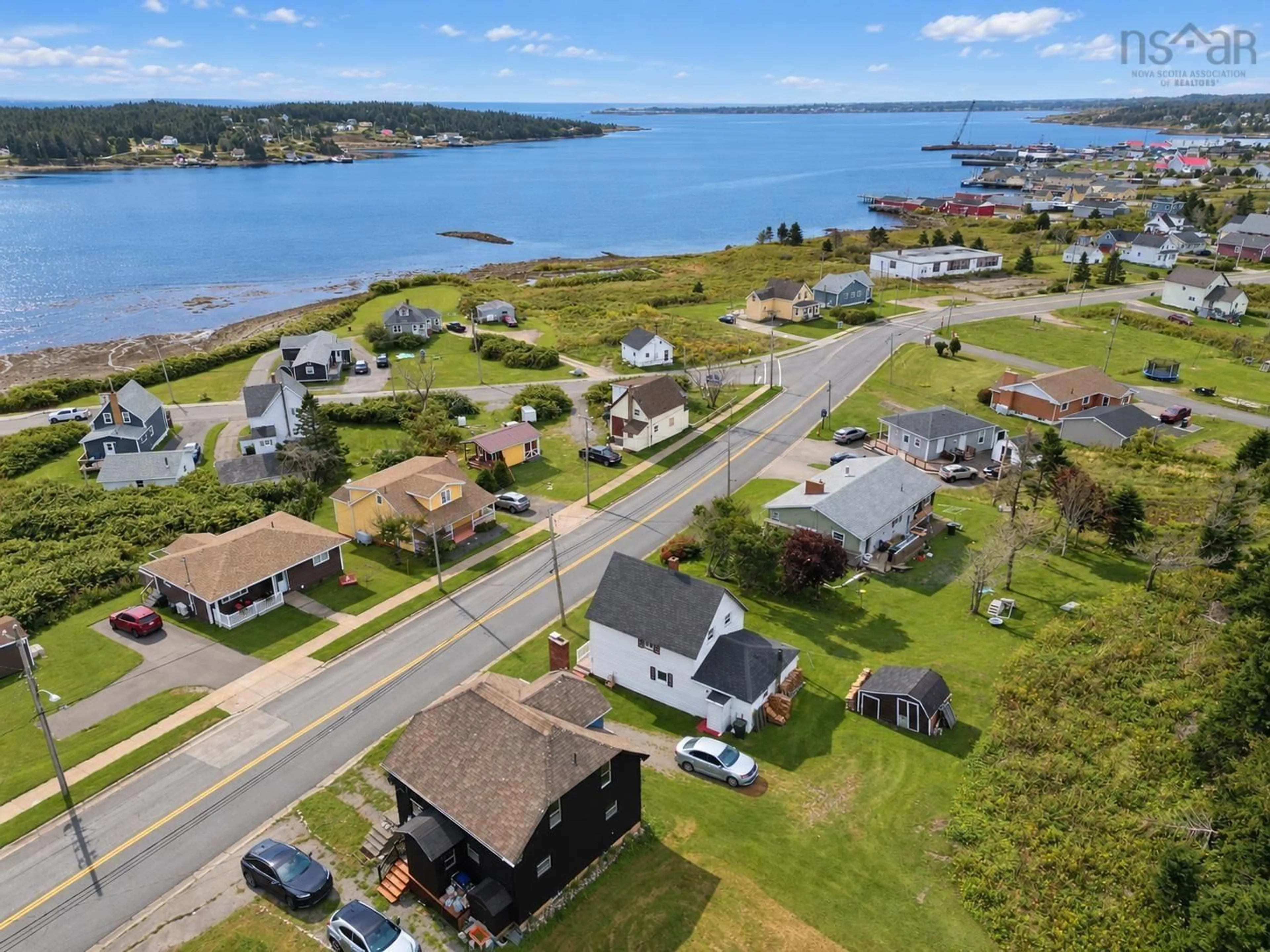 A pic from outside/outdoor area/front of a property/back of a property/a pic from drone, water/lake/river/ocean view for 7368 Main St, Louisbourg Nova Scotia B1C 1P5