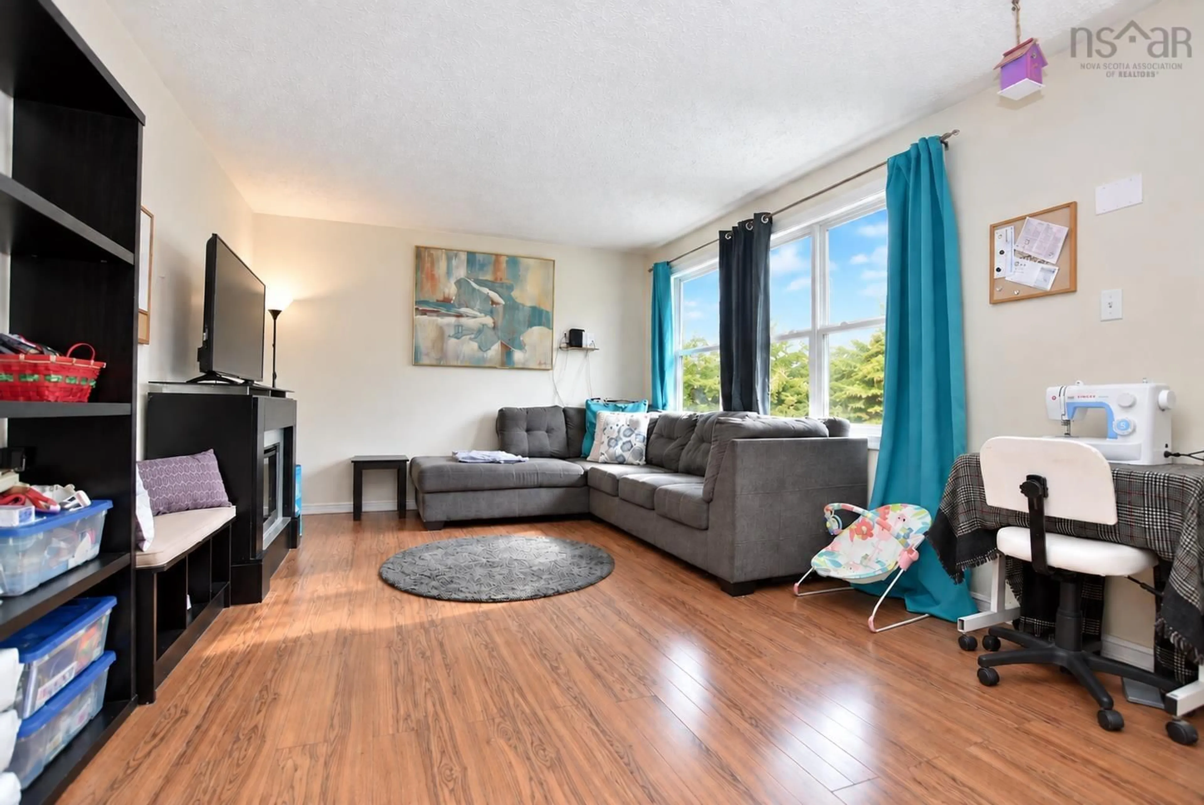 Living room with furniture, wood/laminate floor for 2925 No. 7 Hwy, Lake Echo Nova Scotia B3E 1A4