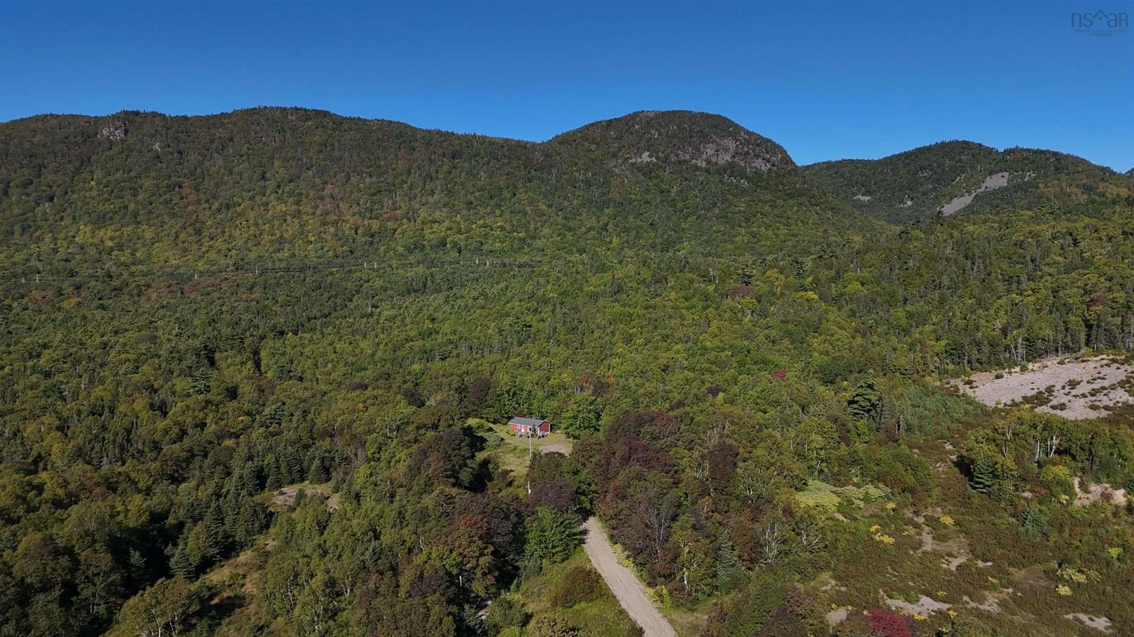 A pic from outside/outdoor area/front of a property/back of a property/a pic from drone, forest/trees view for 101 Millbrook Road, Wreck Cove Nova Scotia B0C 1H0