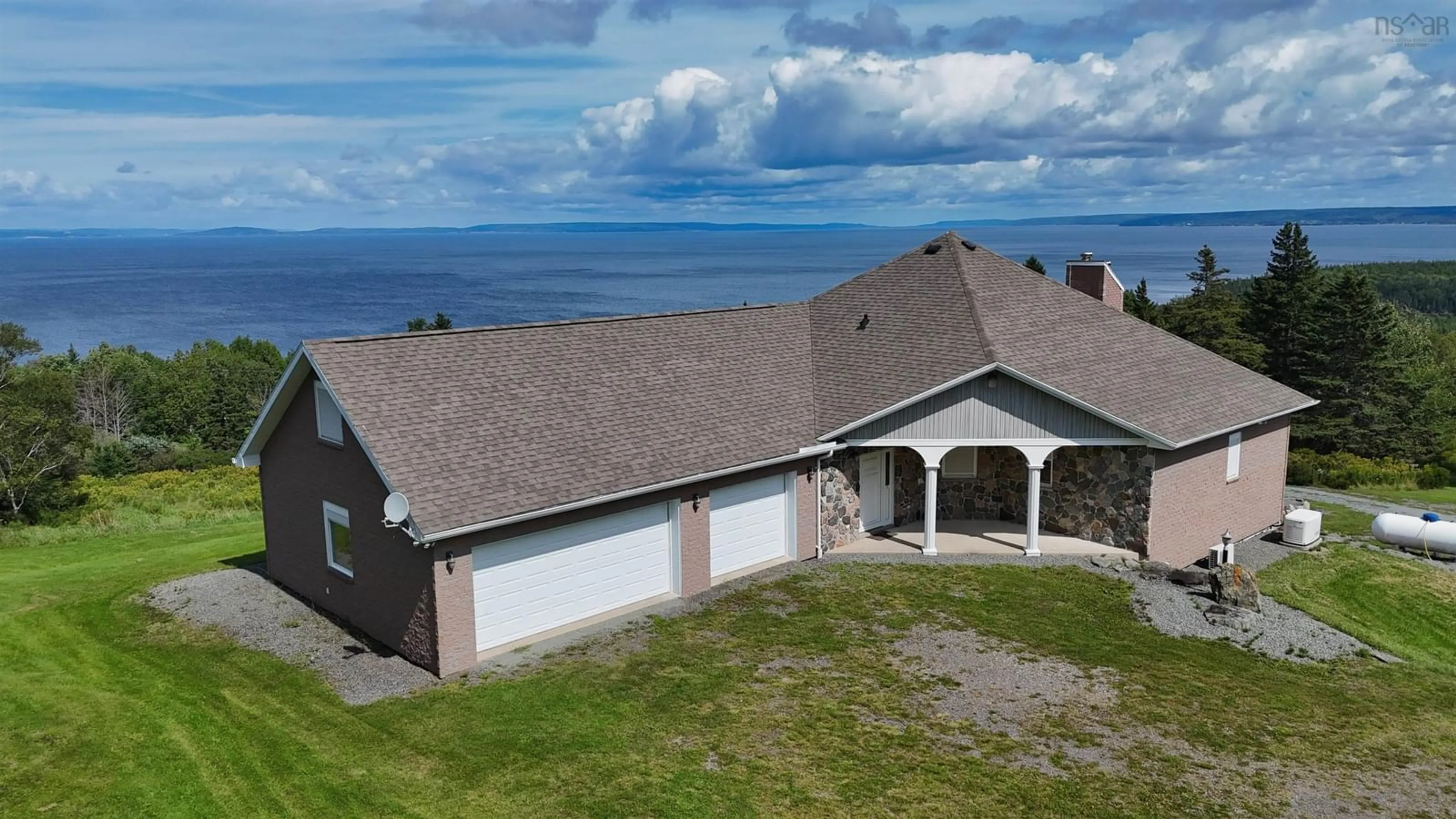A pic from outside/outdoor area/front of a property/back of a property/a pic from drone, water/lake/river/ocean view for 6260 West Bay Rd, Roberta Nova Scotia B0E 3K0