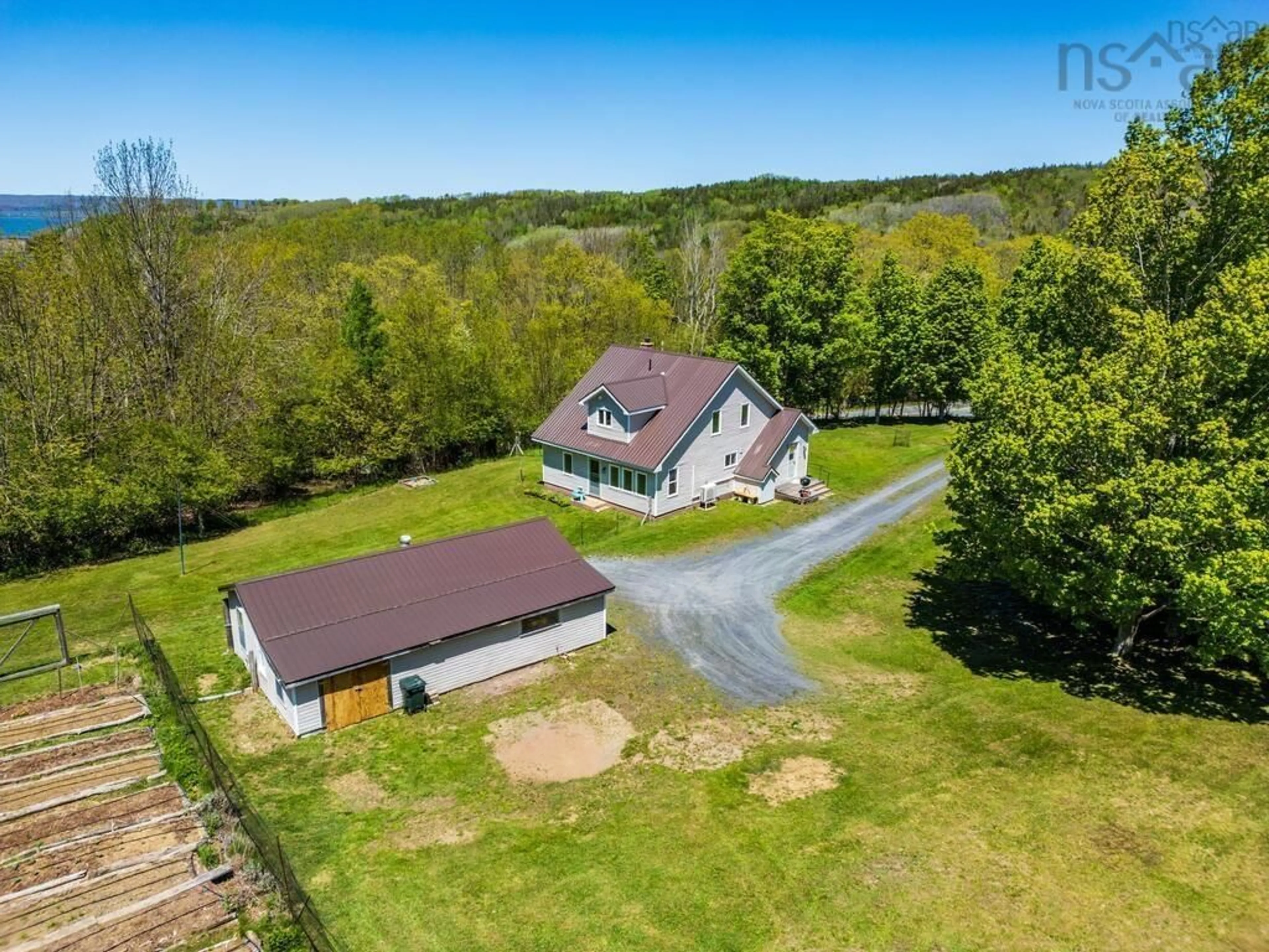 A pic from outside/outdoor area/front of a property/back of a property/a pic from drone, water/lake/river/ocean view for 550 River Rd, Bear River Nova Scotia B0S 1B0
