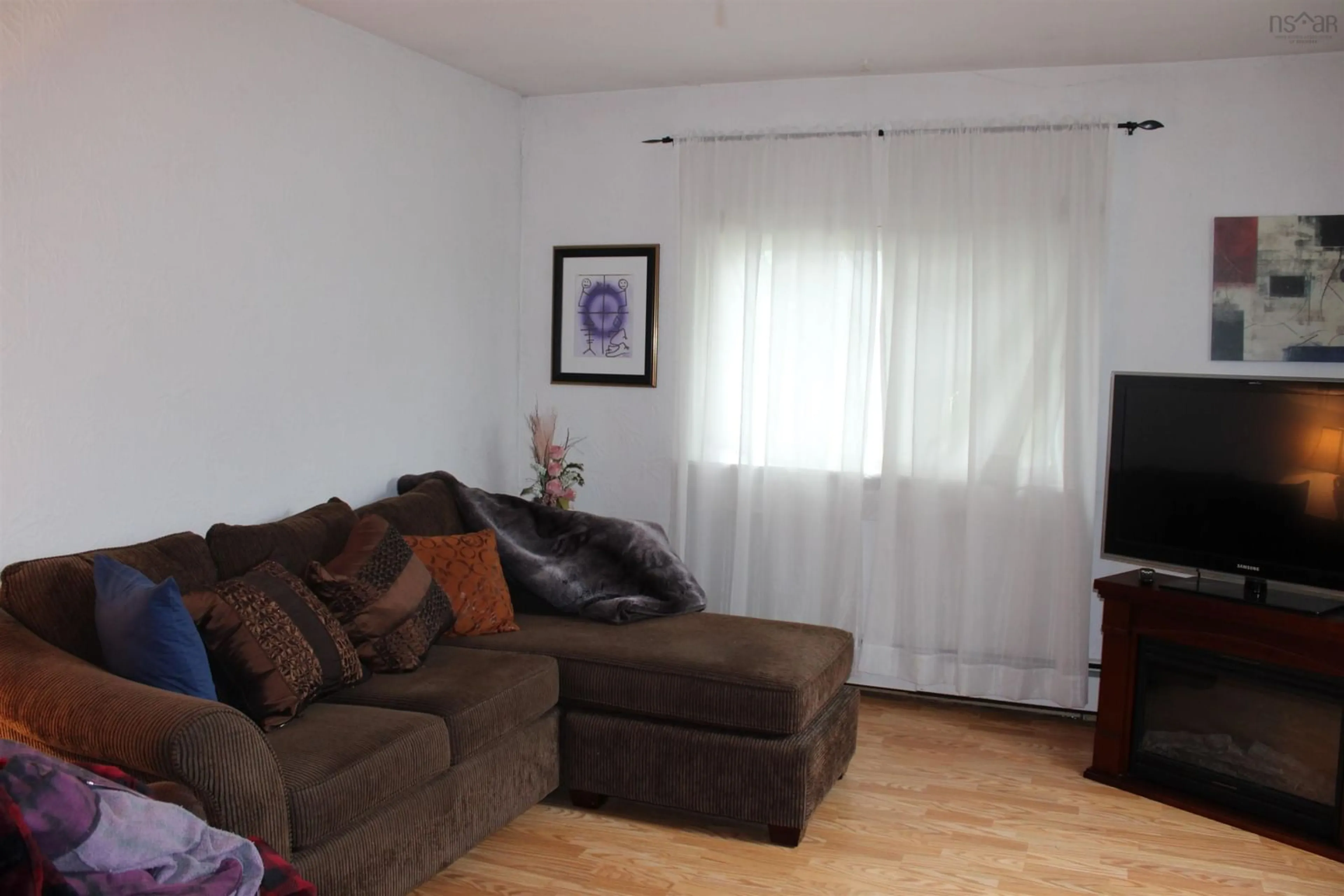 Living room with furniture, wood/laminate floor for 404 East Chezzetcook Rd, East Chezzetcook Nova Scotia B0J 2L0