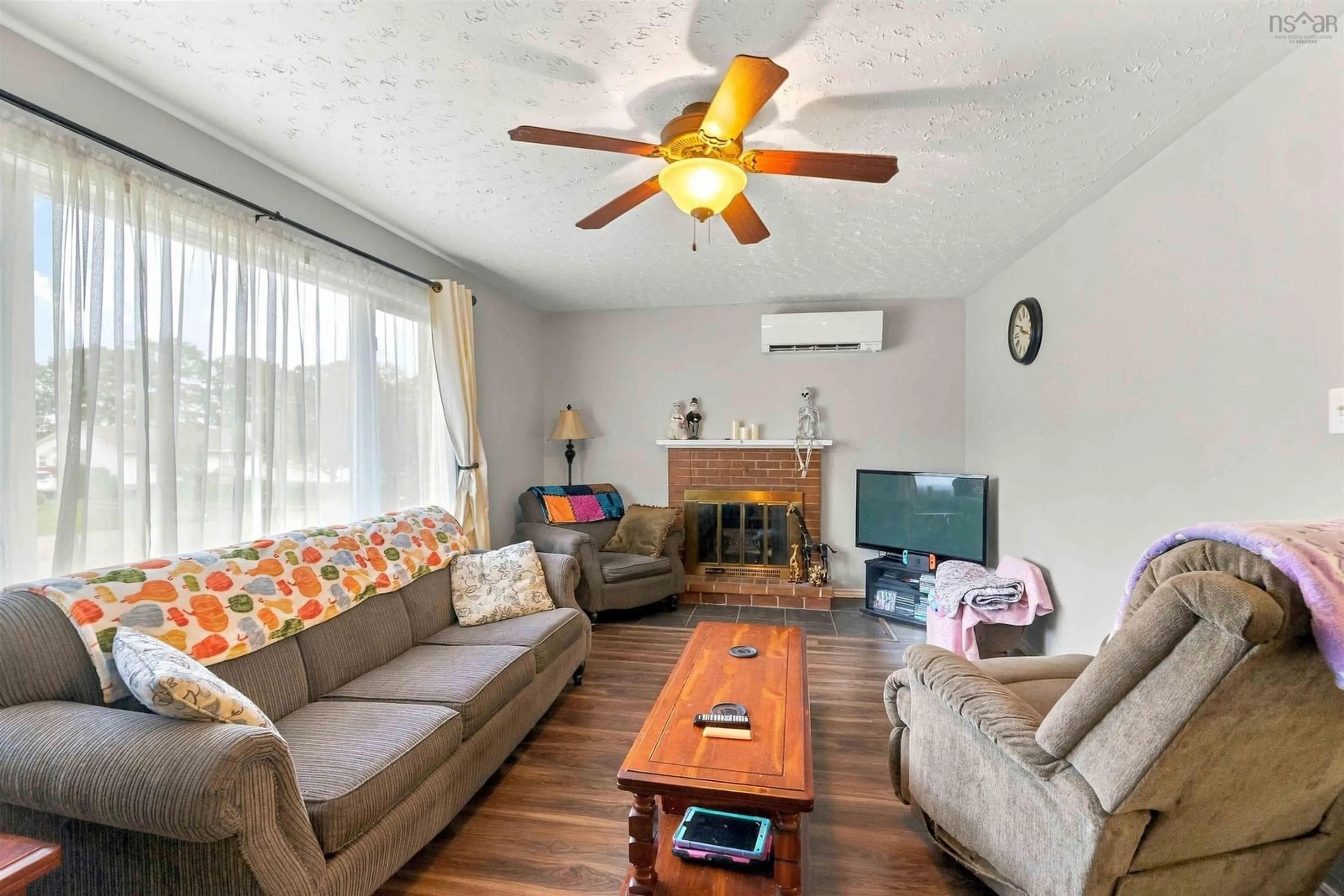 Living room with furniture, wood/laminate floor for 1130 Aalders Ave, New Minas Nova Scotia B4N 3H5