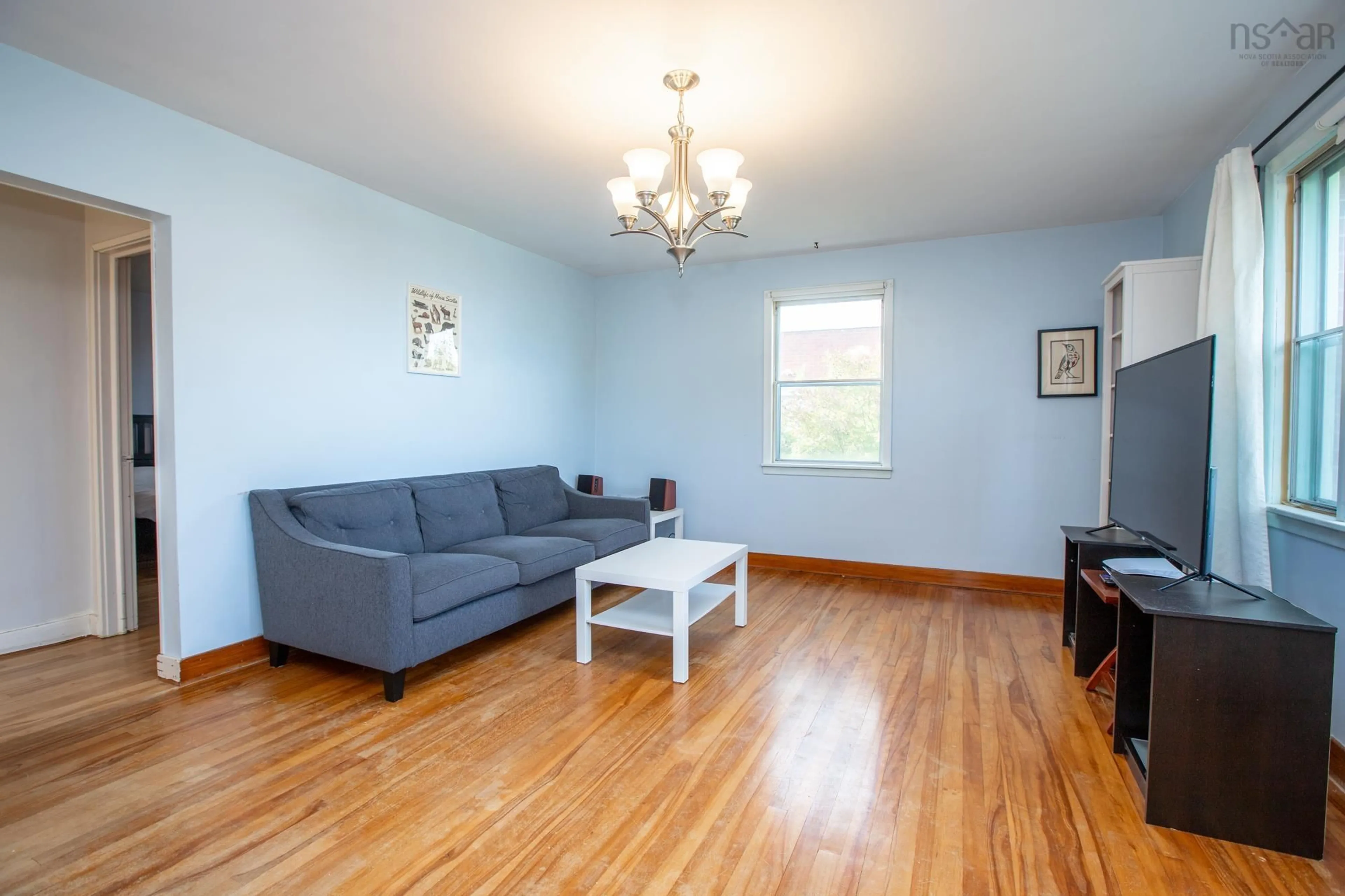 Living room with furniture, wood/laminate floor for 16 Juniper Cres, Spryfield Nova Scotia B3R 2H4