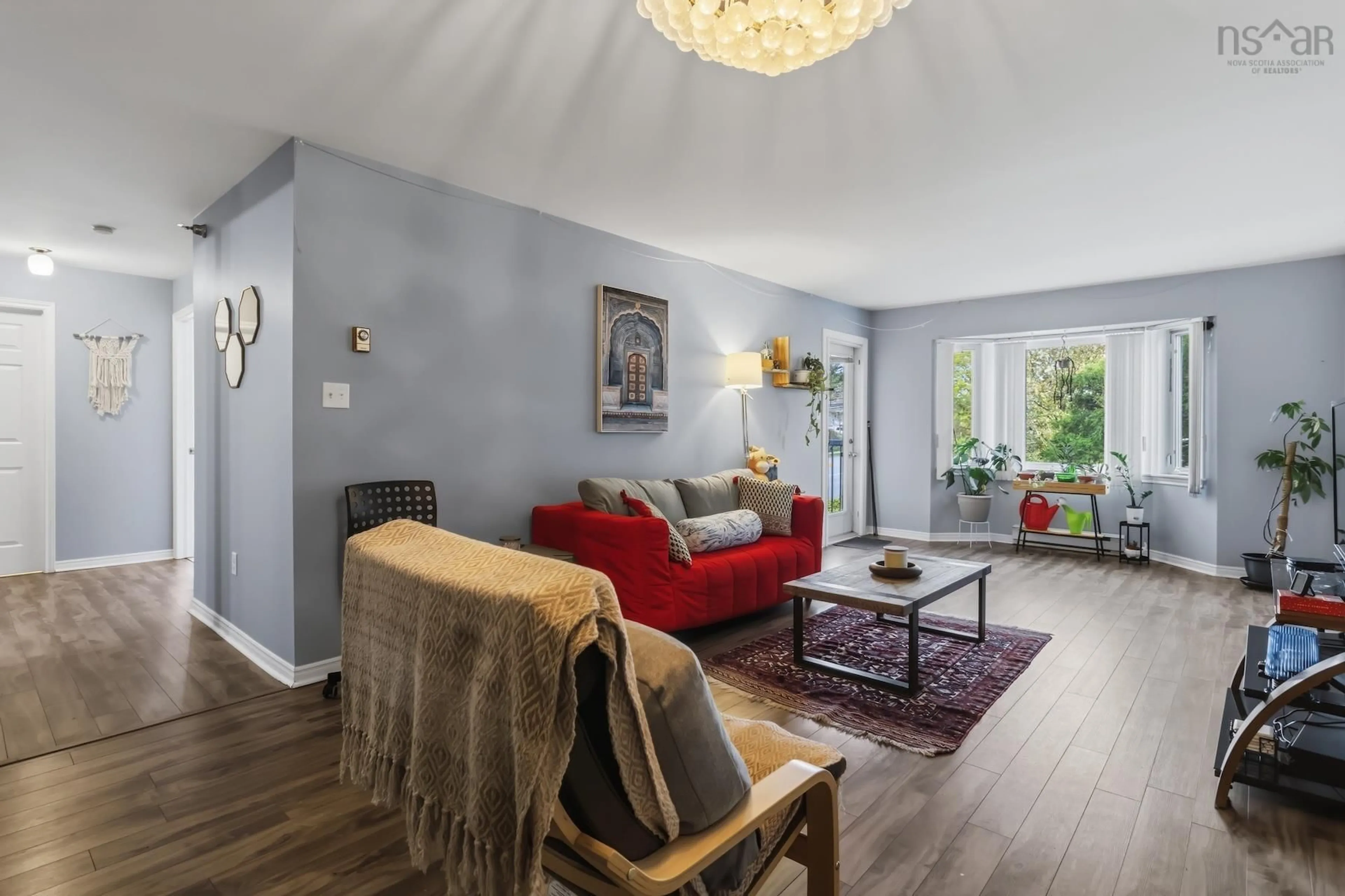 Living room with furniture, wood/laminate floor for 83 Kearney Lake Rd #202, Halifax Nova Scotia B3M 4E6