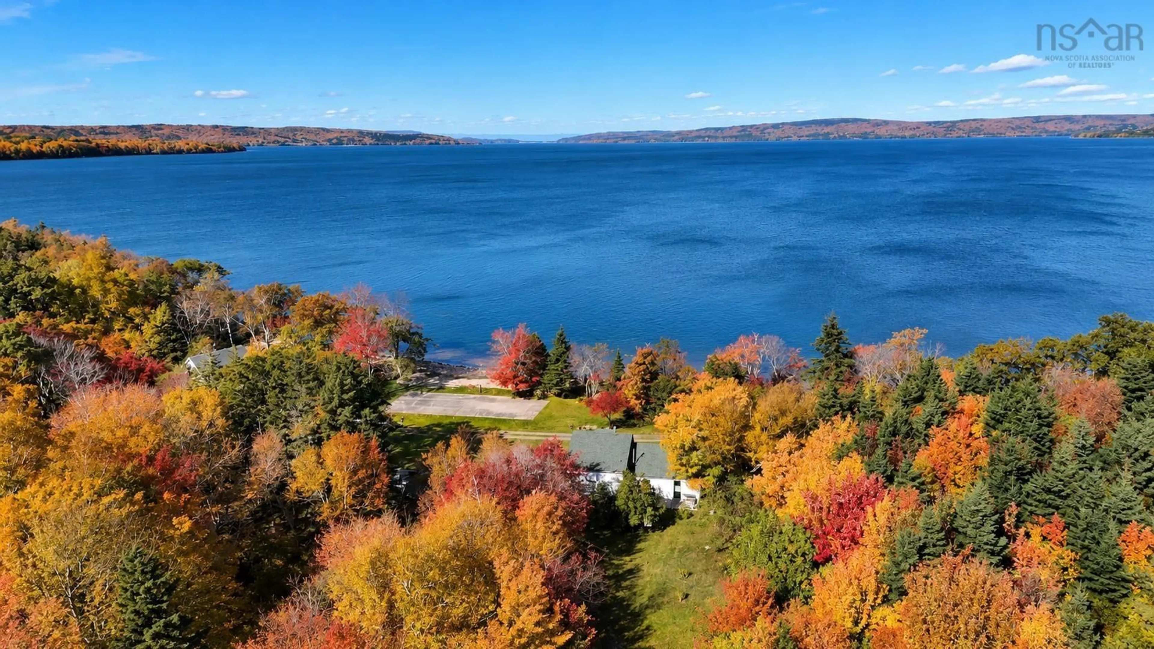 A pic from outside/outdoor area/front of a property/back of a property/a pic from drone, water/lake/river/ocean view for 2477 Highway 395, East Lake Ainslie Nova Scotia B0E 3M0