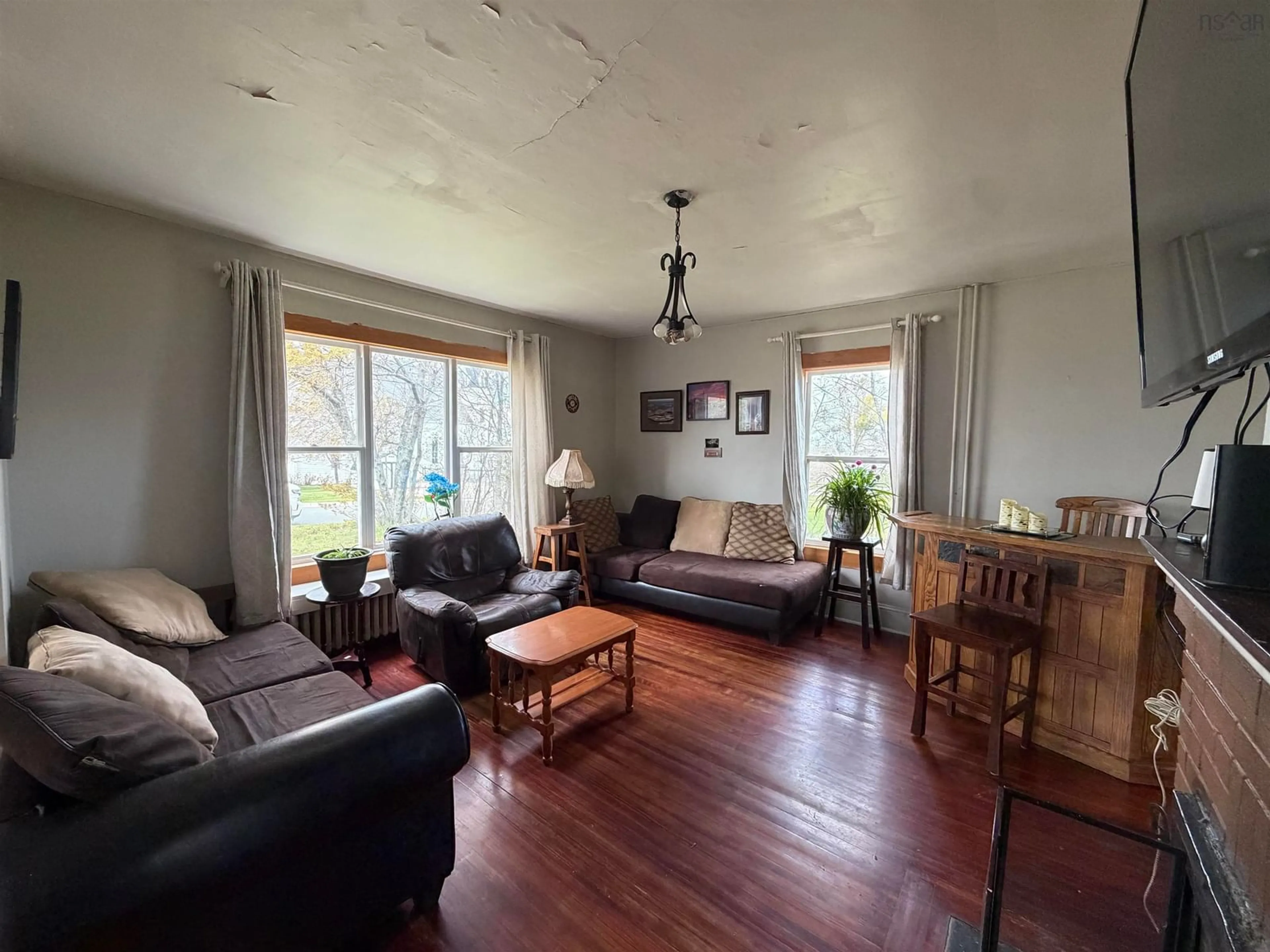 Living room with furniture, wood/laminate floor for 568 George St, New Waterford Nova Scotia B1H 4E3