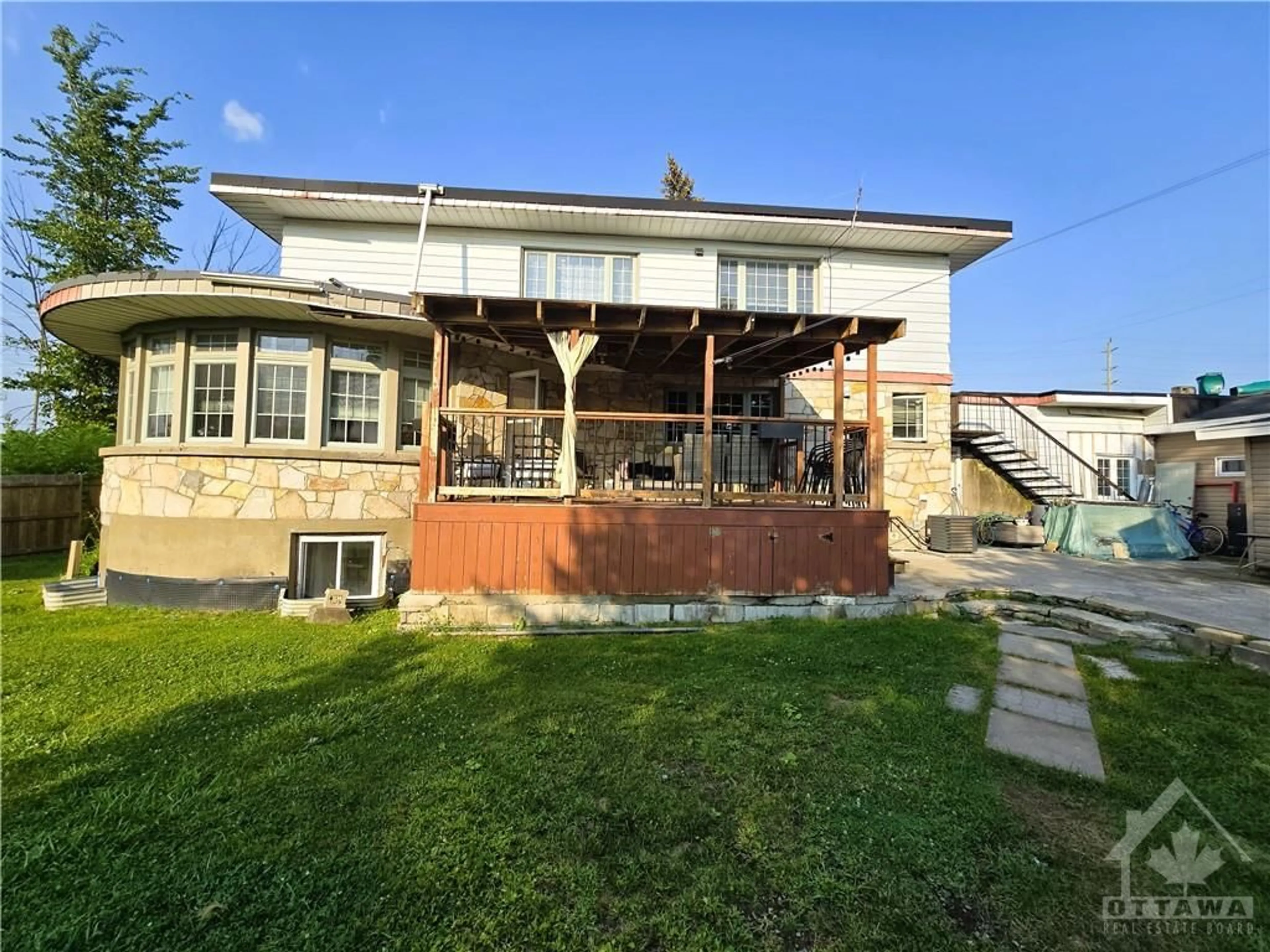 Frontside or backside of a home, the fenced backyard for 1196 RAINBOW St, Ottawa Ontario K1J 6X9