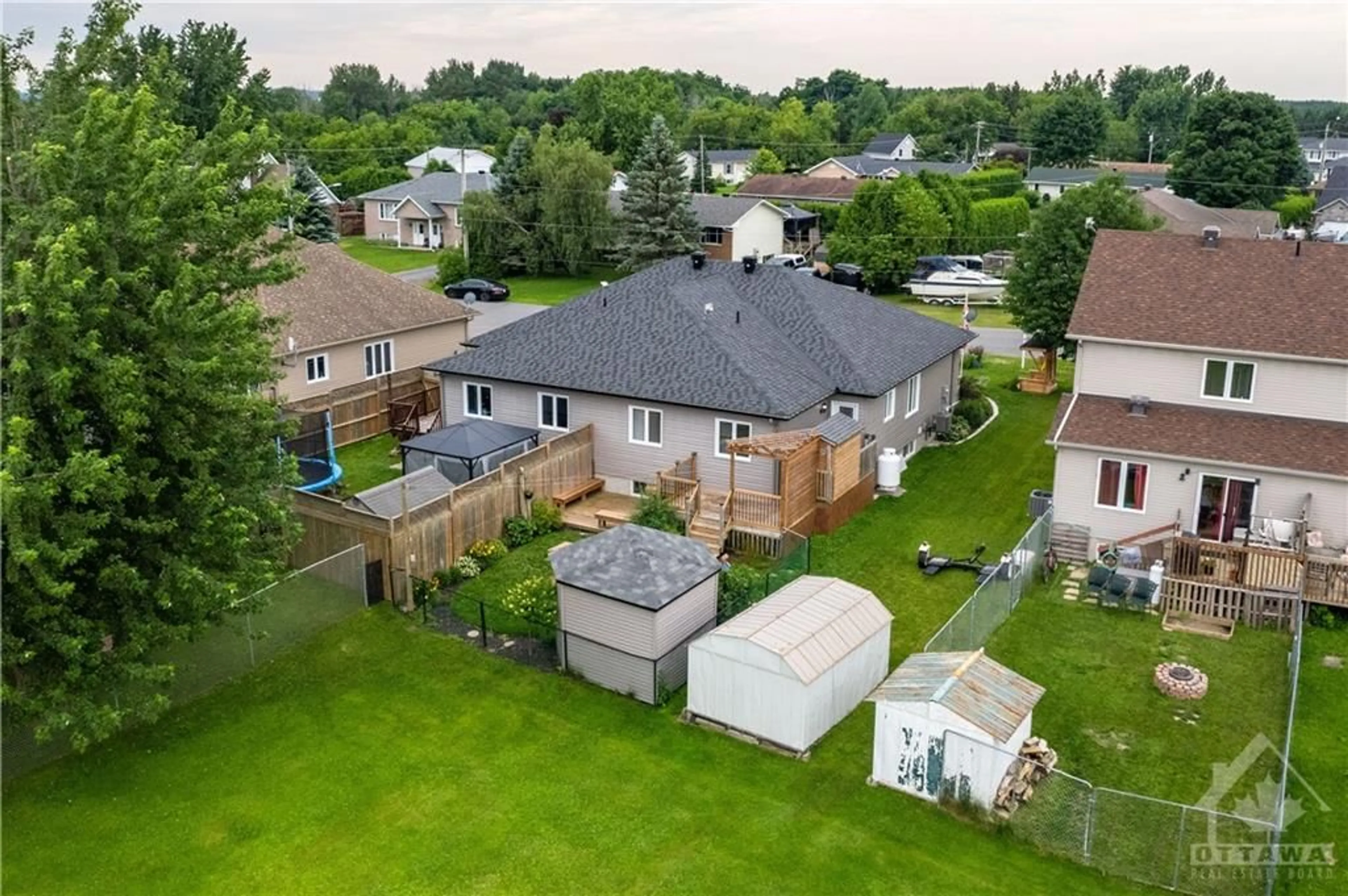 Frontside or backside of a home, the fenced backyard for 15 GAREAU Cres, St Isidore Ontario K0C 2B0