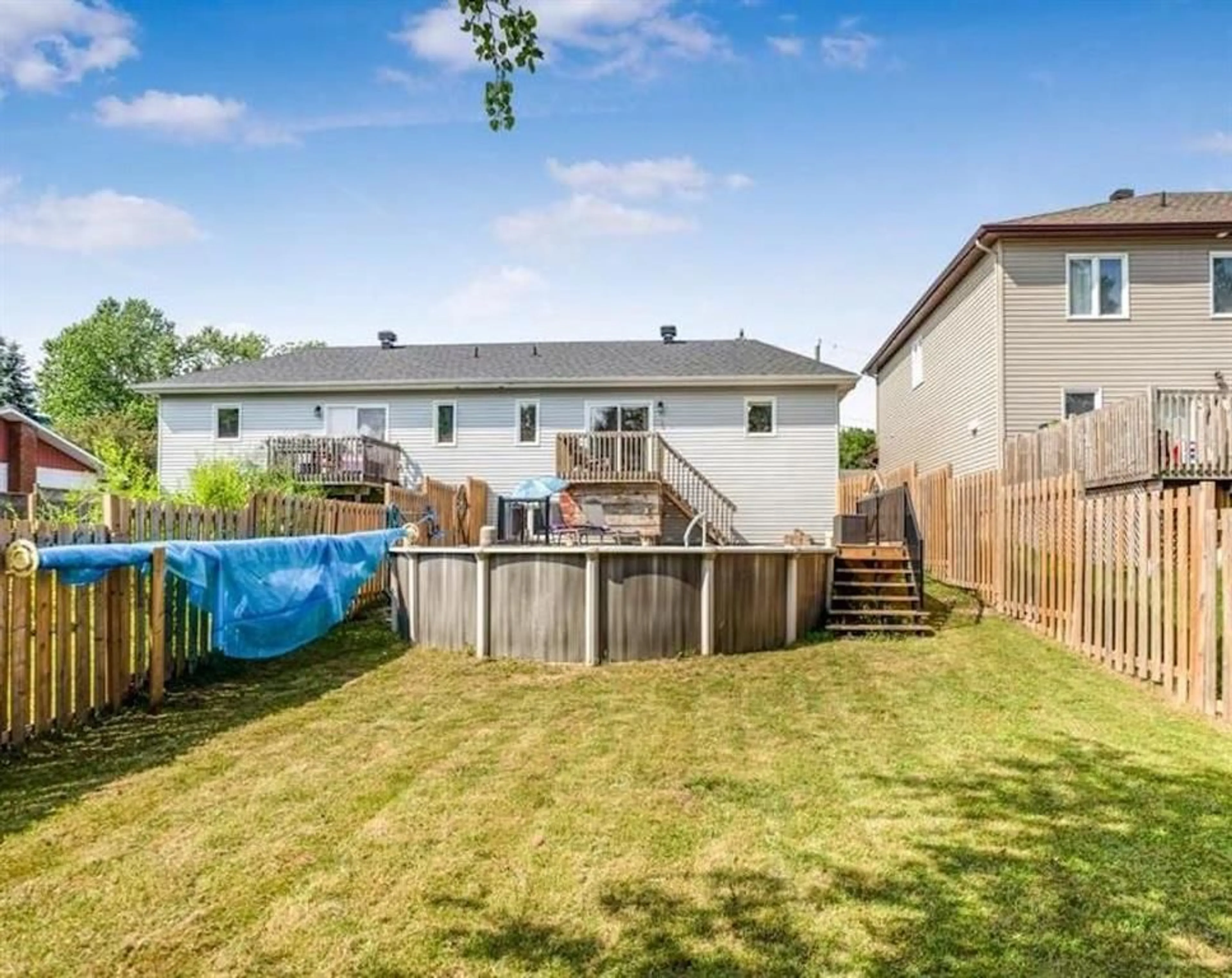 Frontside or backside of a home, the fenced backyard for 196 HERBERT St, Limoges Ontario K0A 2M0