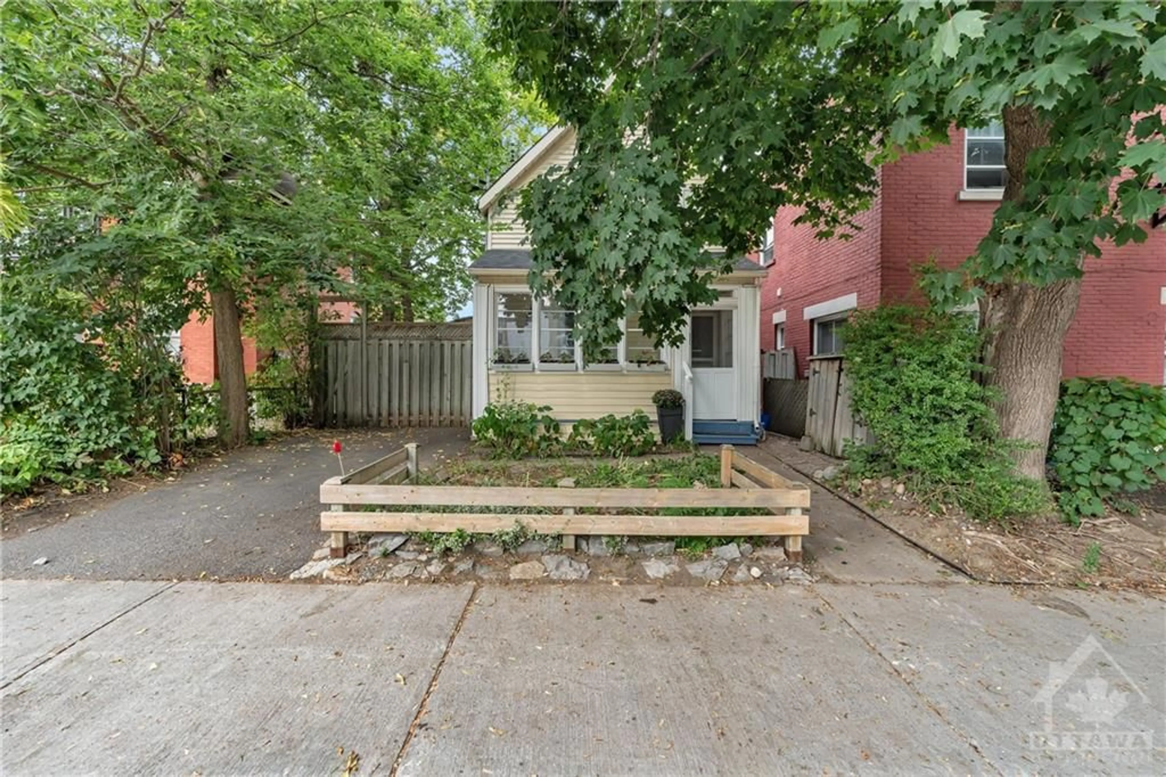 A pic from exterior of the house or condo, the fenced backyard for 13 LOUISA St, Ottawa Ontario K1R 6Y5