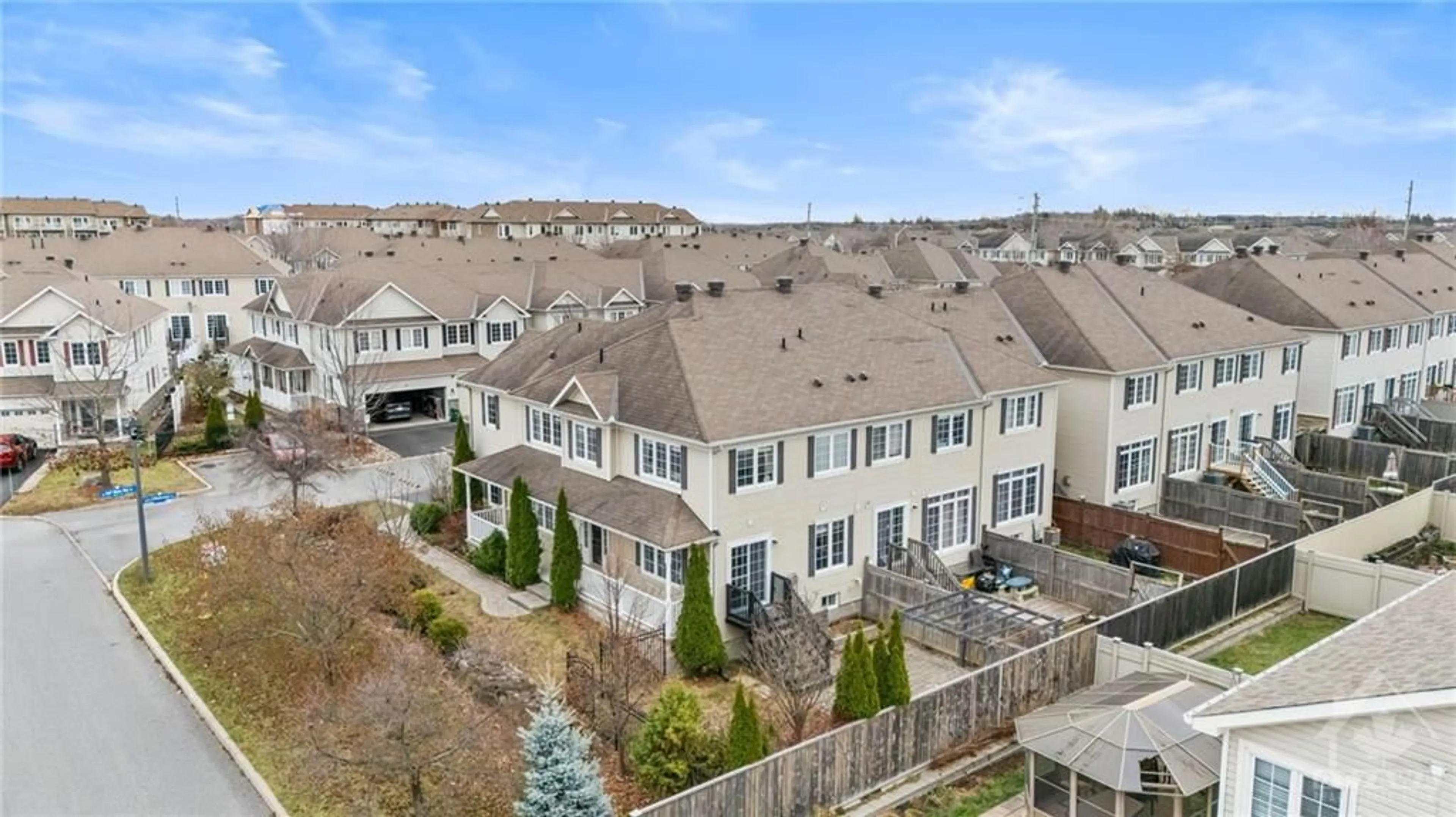 A pic from exterior of the house or condo, the fenced backyard for 100 URBANCREST Pvt, Ottawa Ontario K2J 0Z6