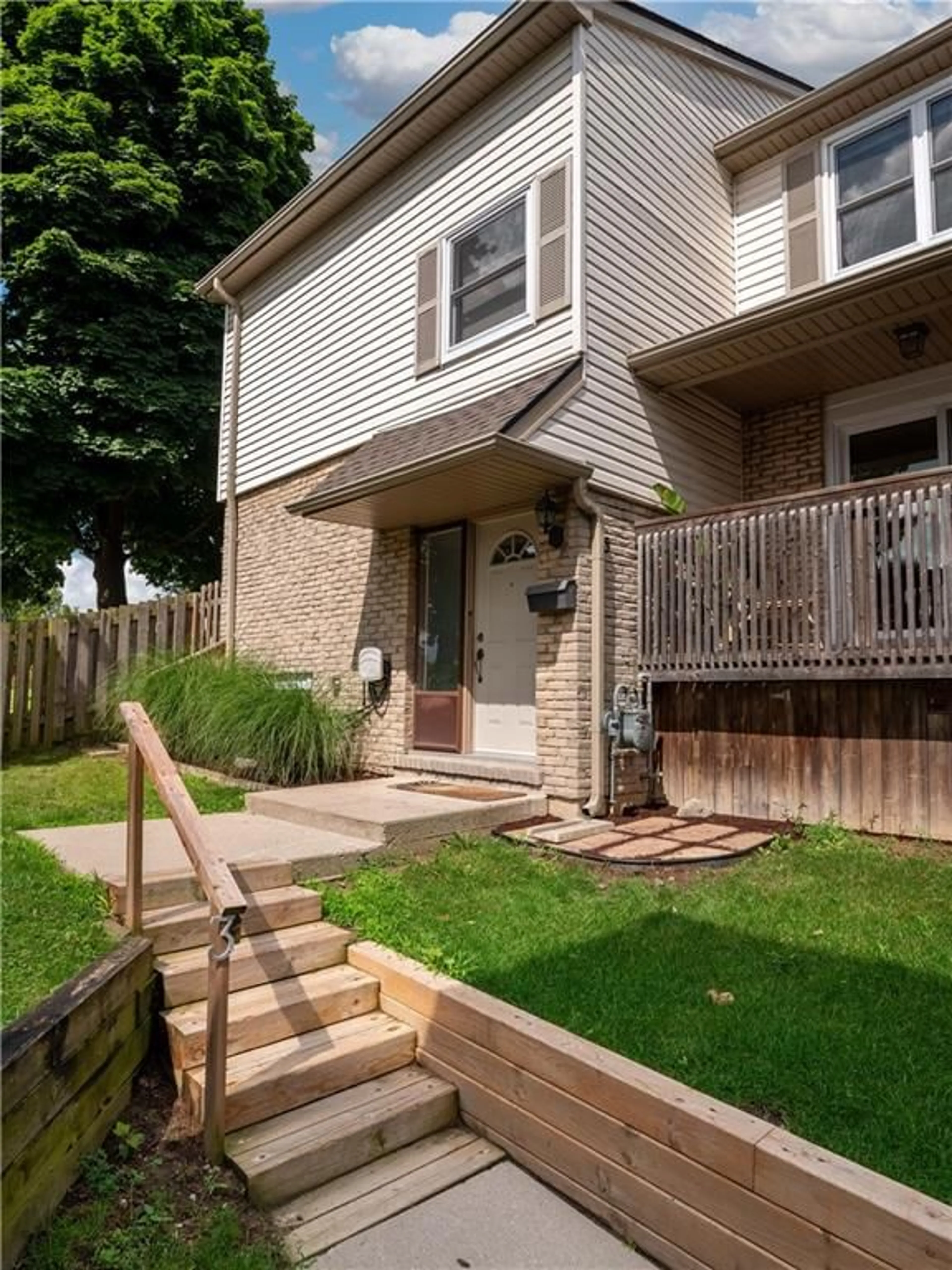 A pic from exterior of the house or condo, the fenced backyard for 1300 UPPER OTTAWA St #3, Hamilton Ontario L8W 1M8