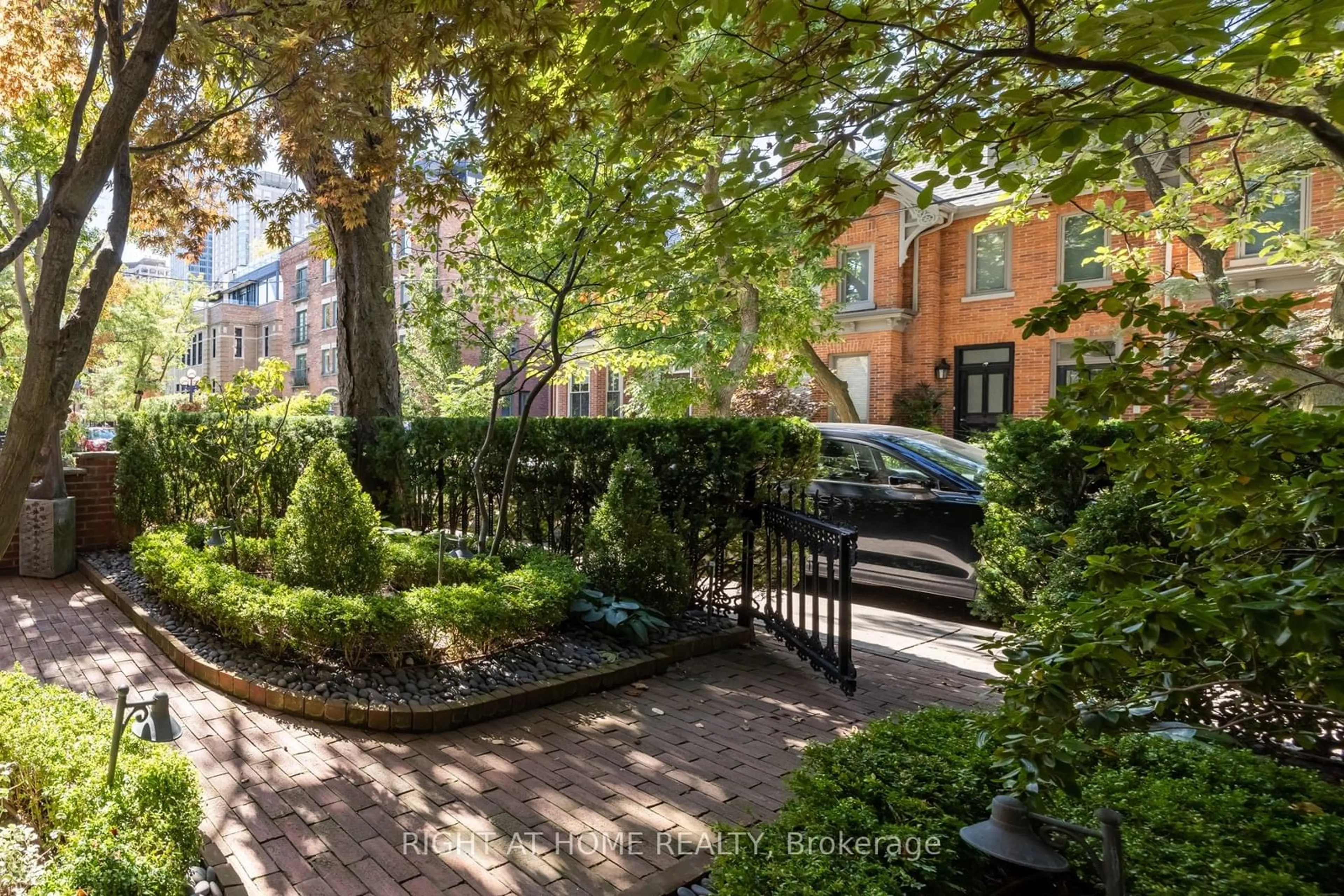 A pic from exterior of the house or condo, the fenced backyard for 51 Hazelton Ave, Toronto Ontario M5R 2E3