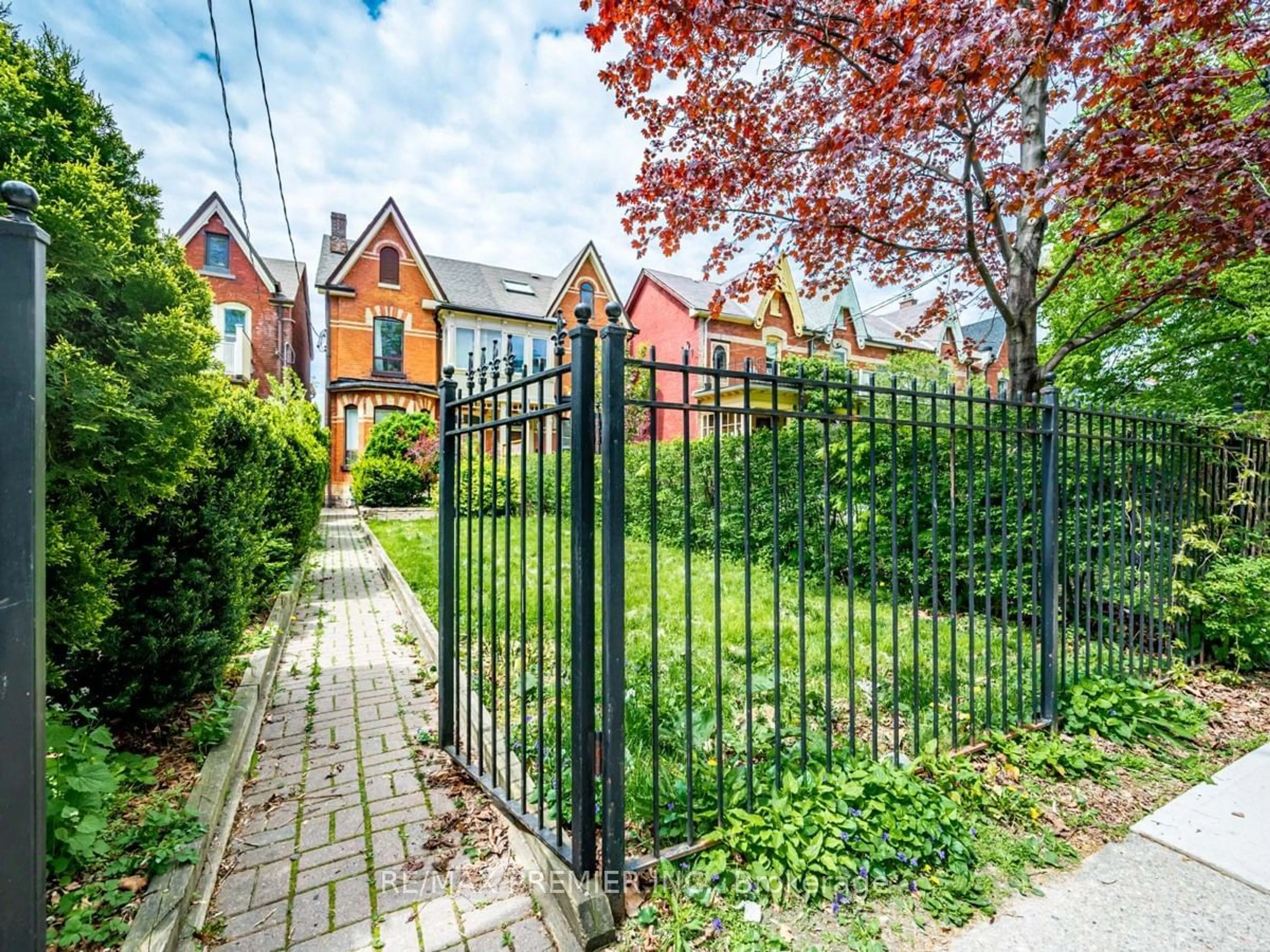 Frontside or backside of a home, the fenced backyard for 102 Bellevue Ave, Toronto Ontario M5T 2N9