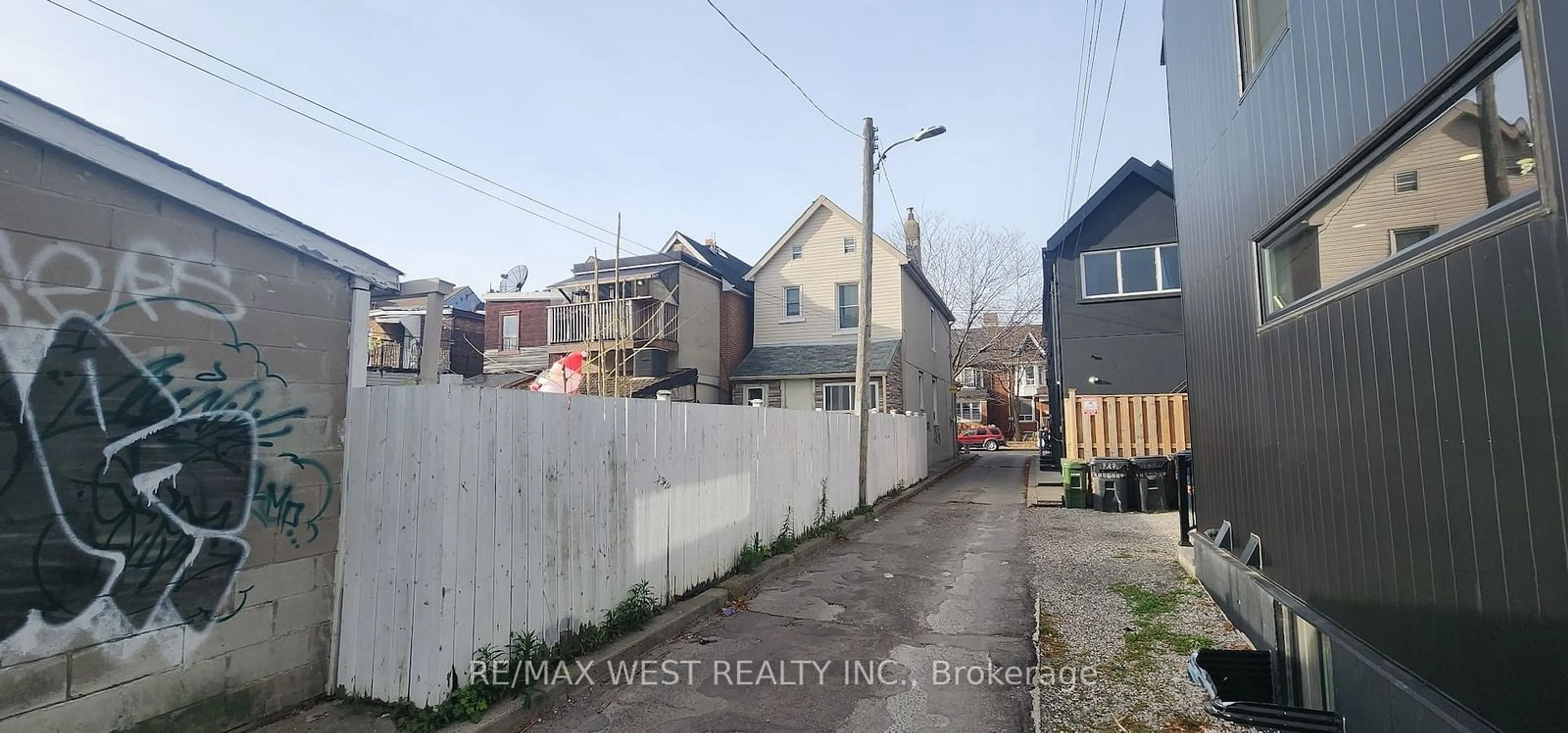 Frontside or backside of a home, the fenced backyard for 521 Lansdowne Ave, Toronto Ontario M6H 3Y2