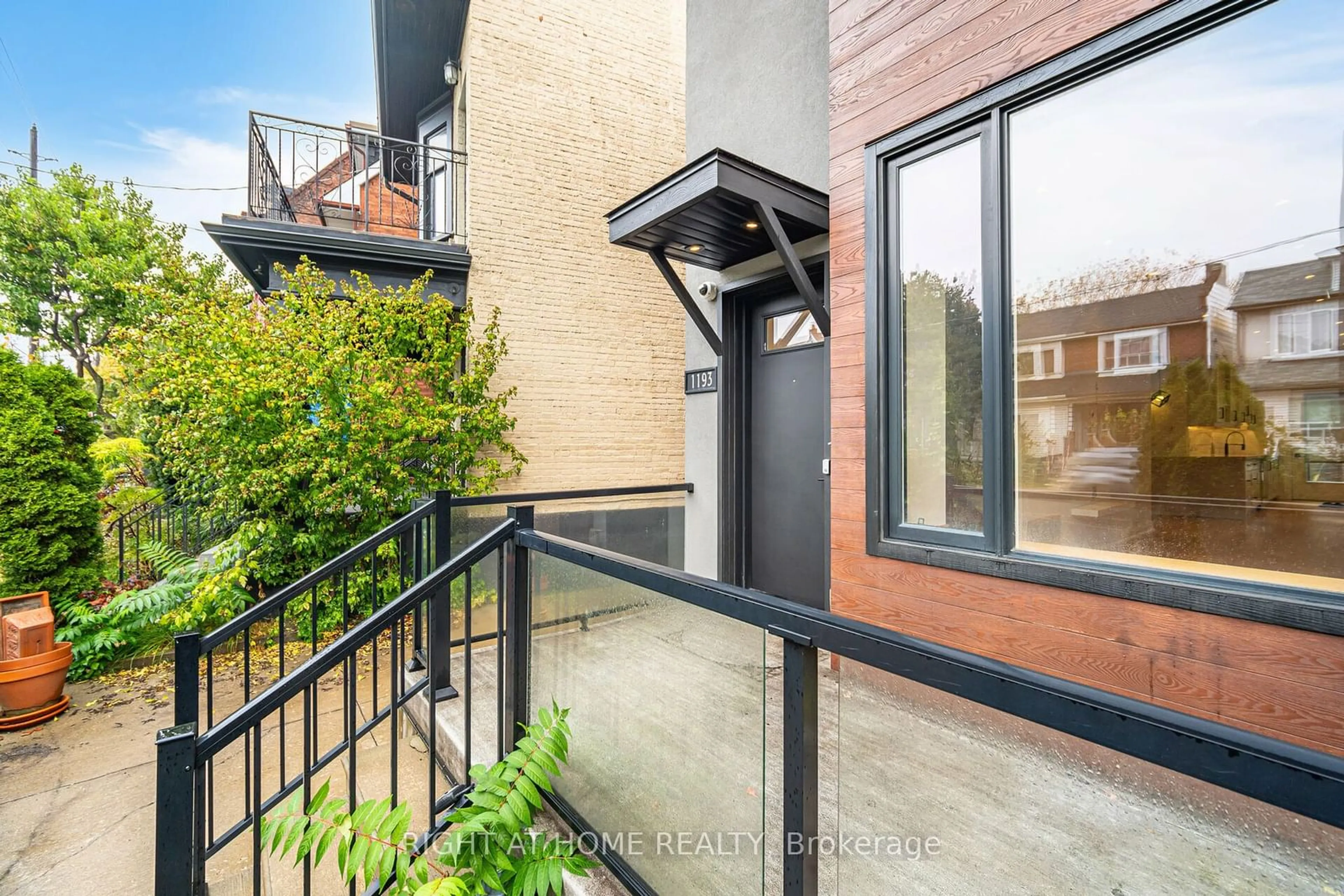 A pic from exterior of the house or condo, the fenced backyard for 1193 Ossington Ave, Toronto Ontario M6G 3W4