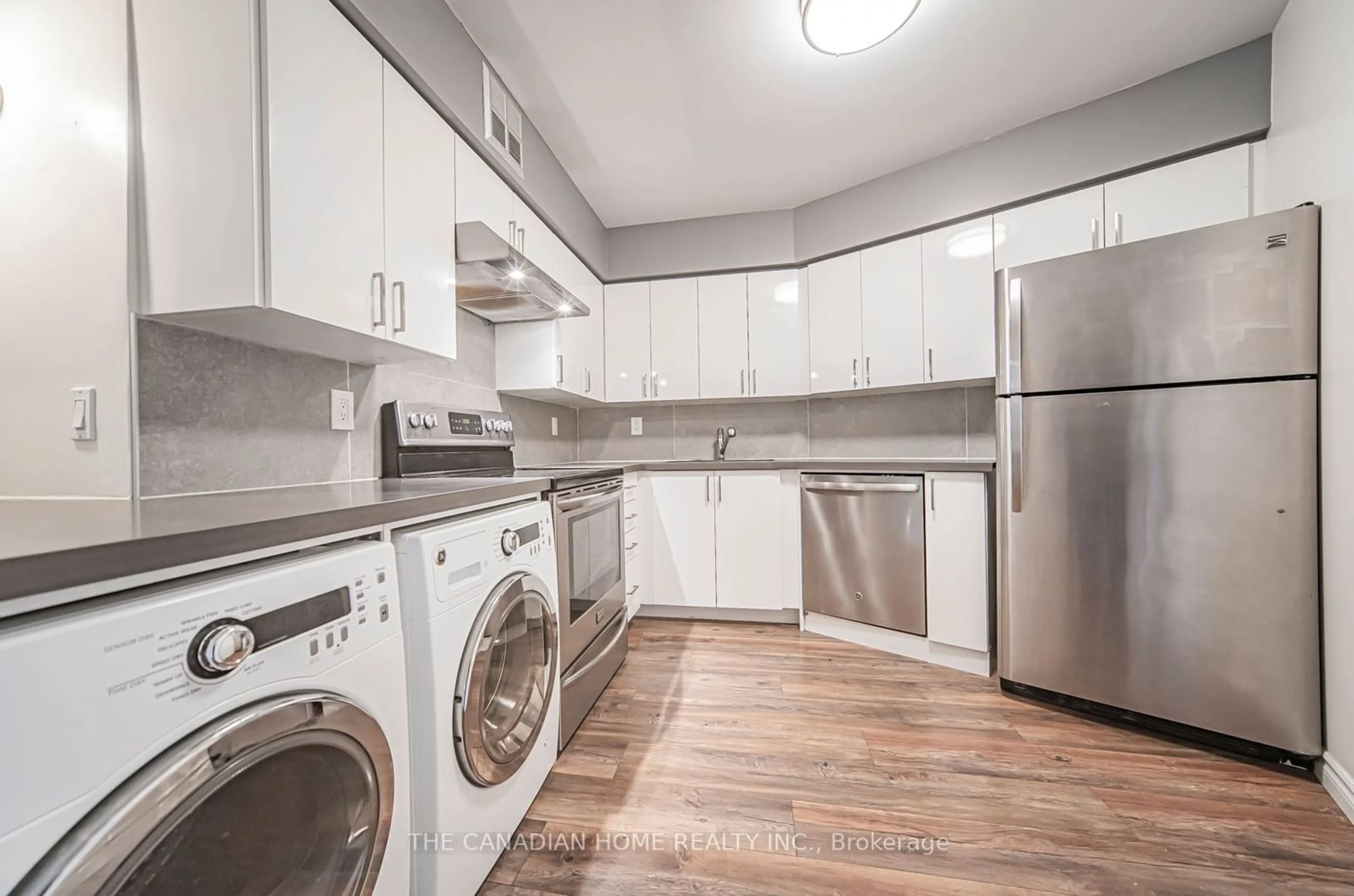 Kitchen with laundary machines, wood floors for 260 Queens Quay #1304, Toronto Ontario M5J 2N3