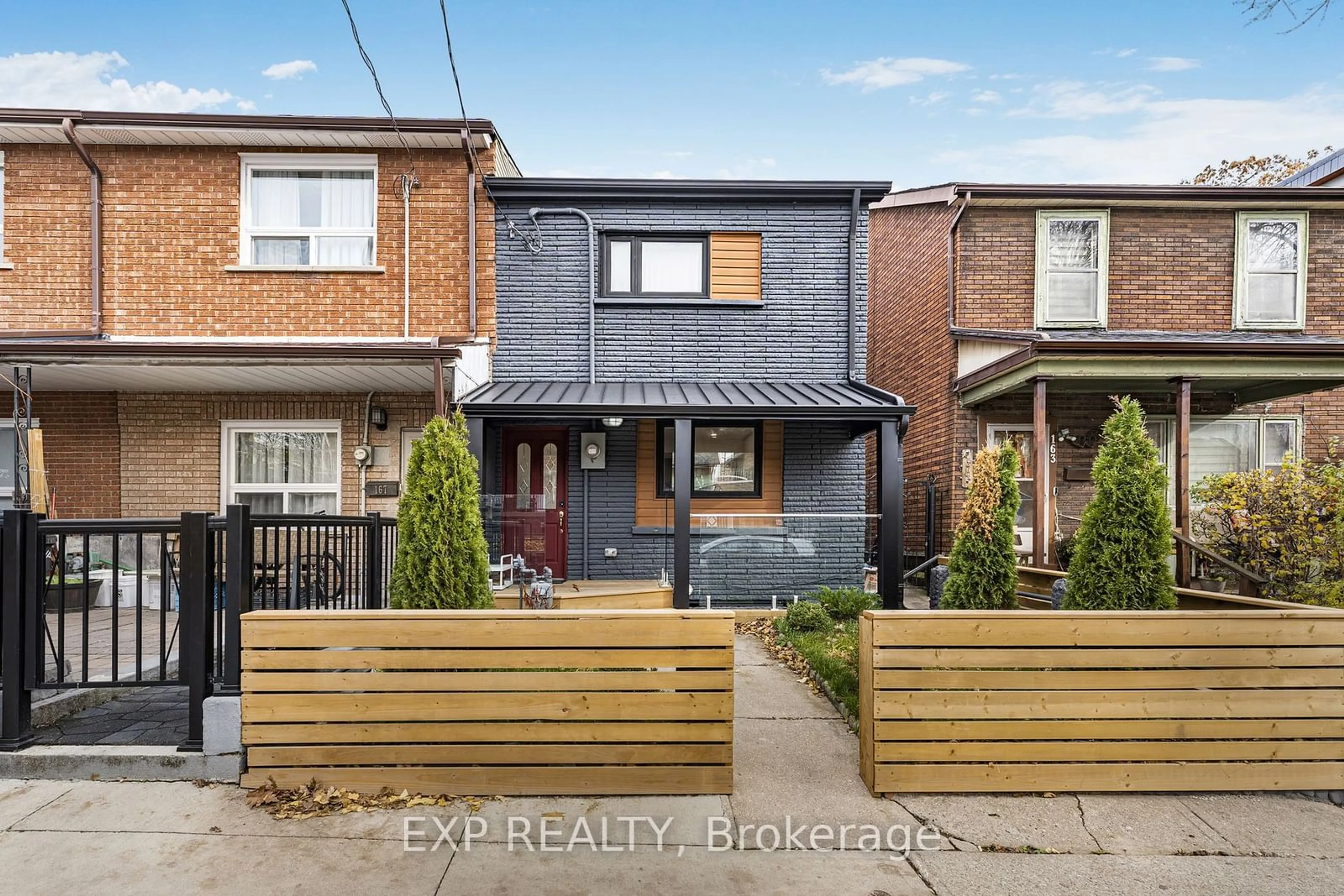 Frontside or backside of a home, the fenced backyard for 165 Claremont St, Toronto Ontario M6J 2M7