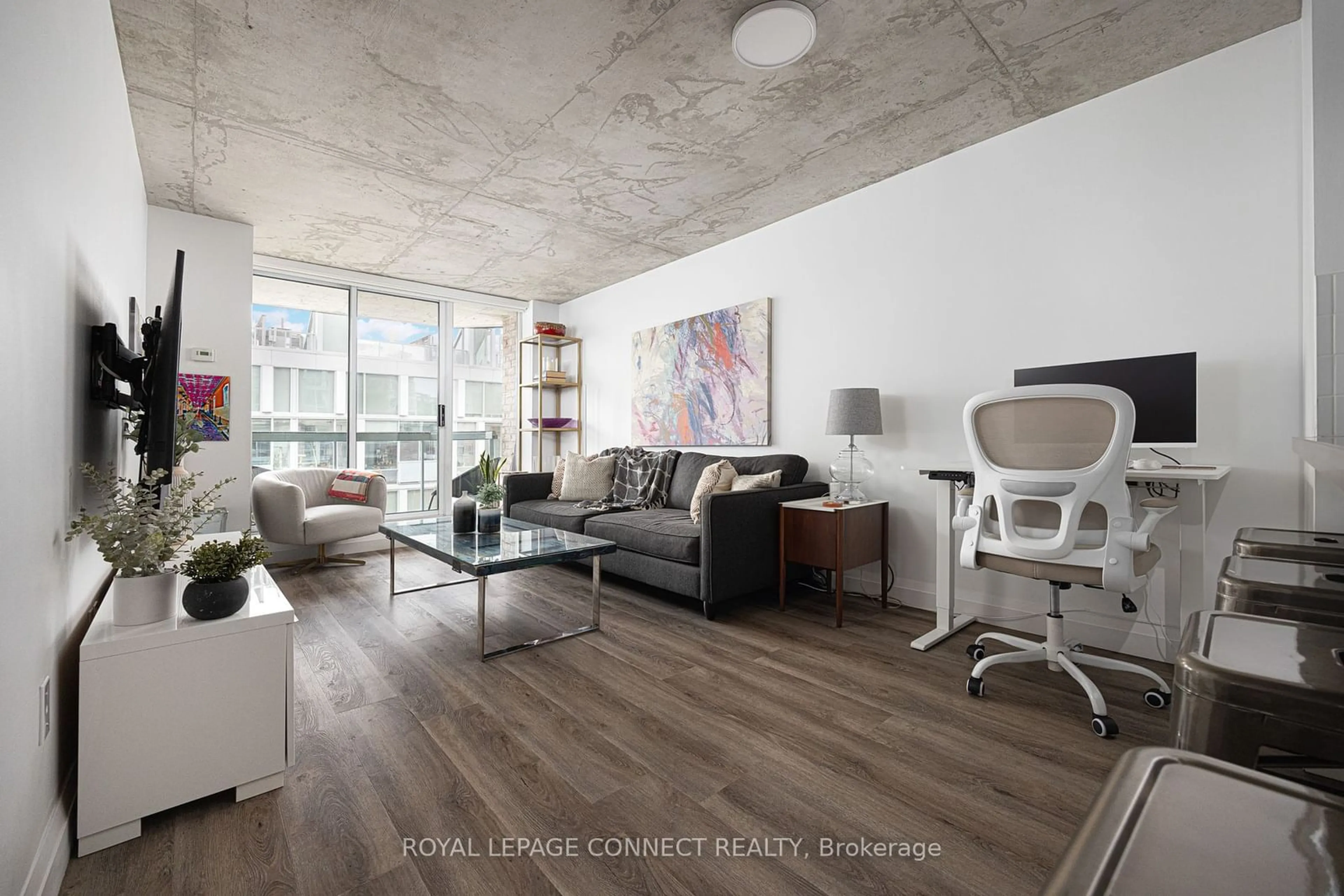 Living room with furniture, cement floor for 311 Richmond St #705, Toronto Ontario M5A 4S8