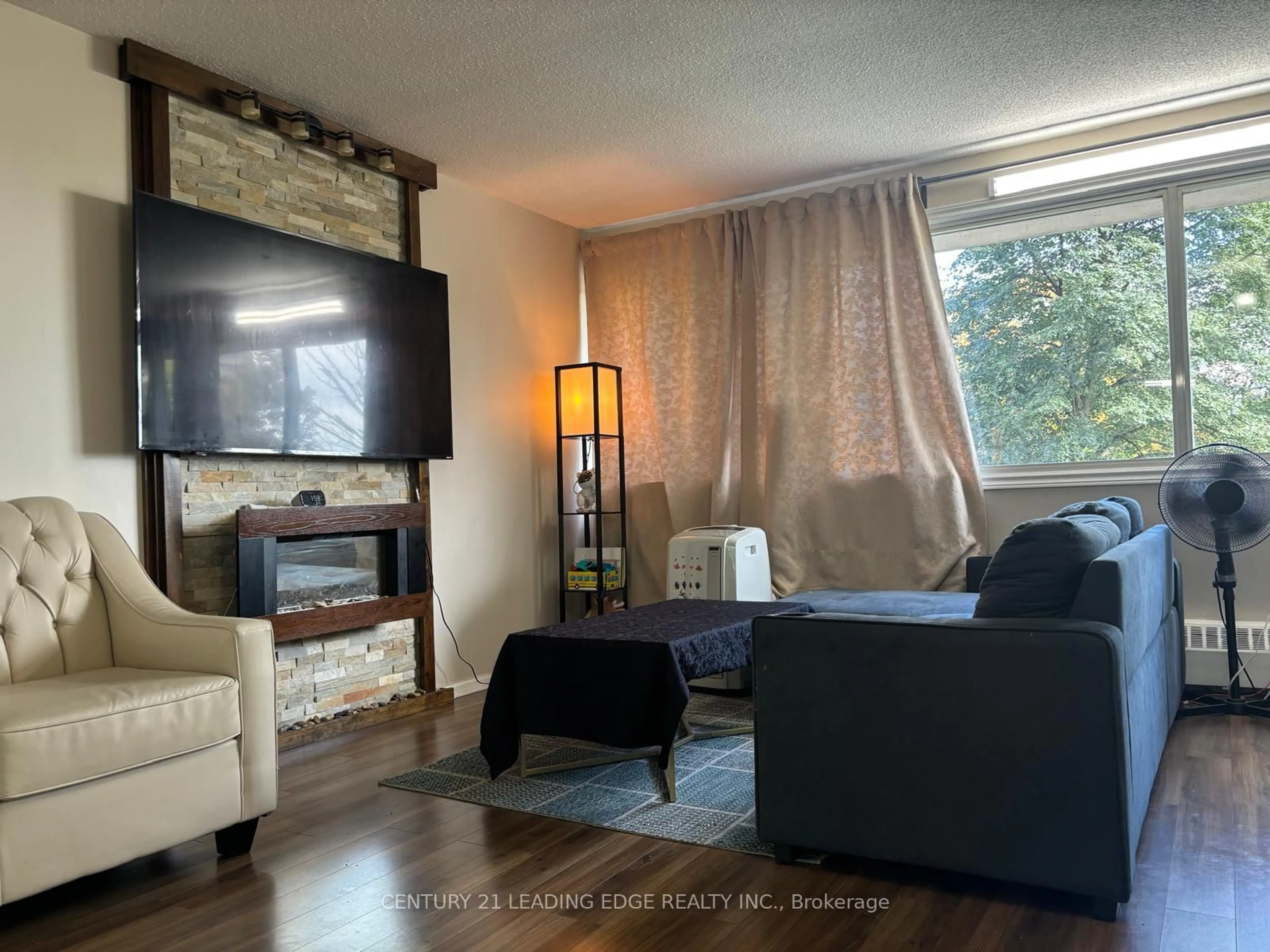 Living room with furniture, wood/laminate floor for 725 Don Mills Rd #401, Toronto Ontario M3C 1S8