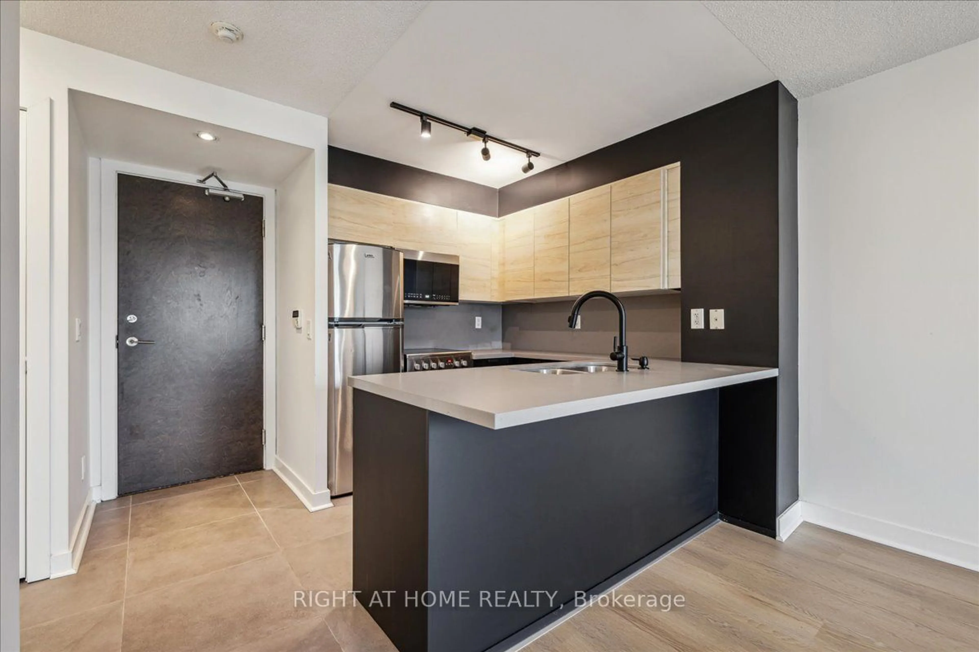 Open concept kitchen, wood/laminate floor for 50 Lynn Williams St #812, Toronto Ontario M6K 3R9